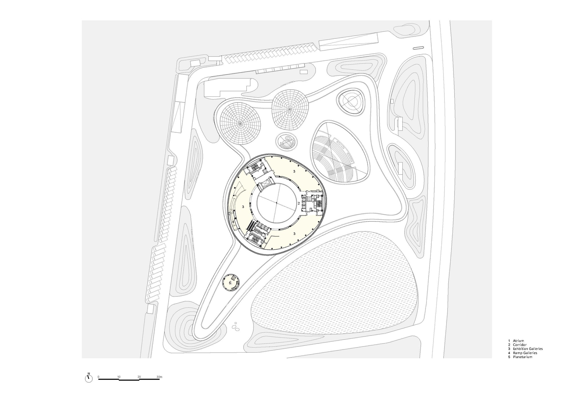 Site plan drawing highlighting one circular building volume within the overall compound
