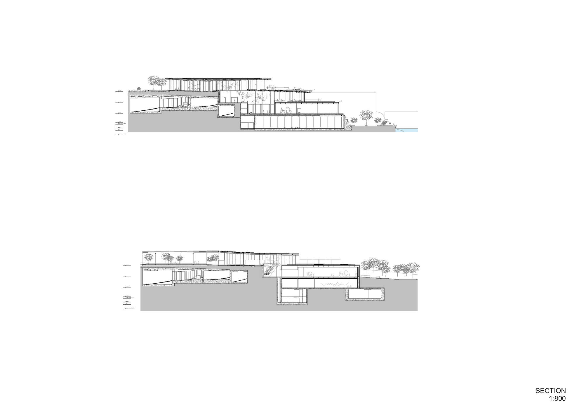 Section drawing showing terraced volumes stepping down the slope toward water with trees
