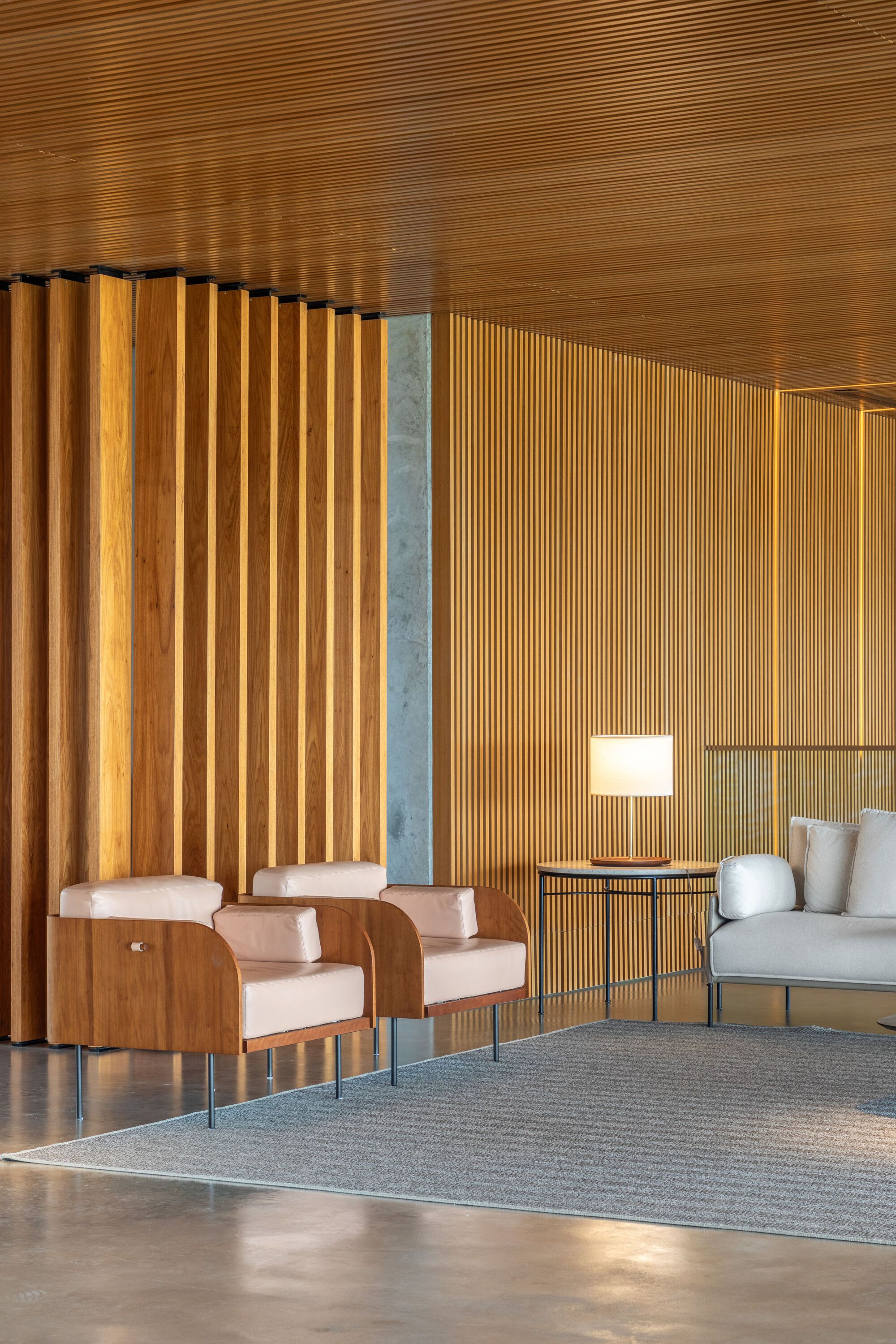 Reception area with vertical timber slat partition and exposed wood plank ceiling
