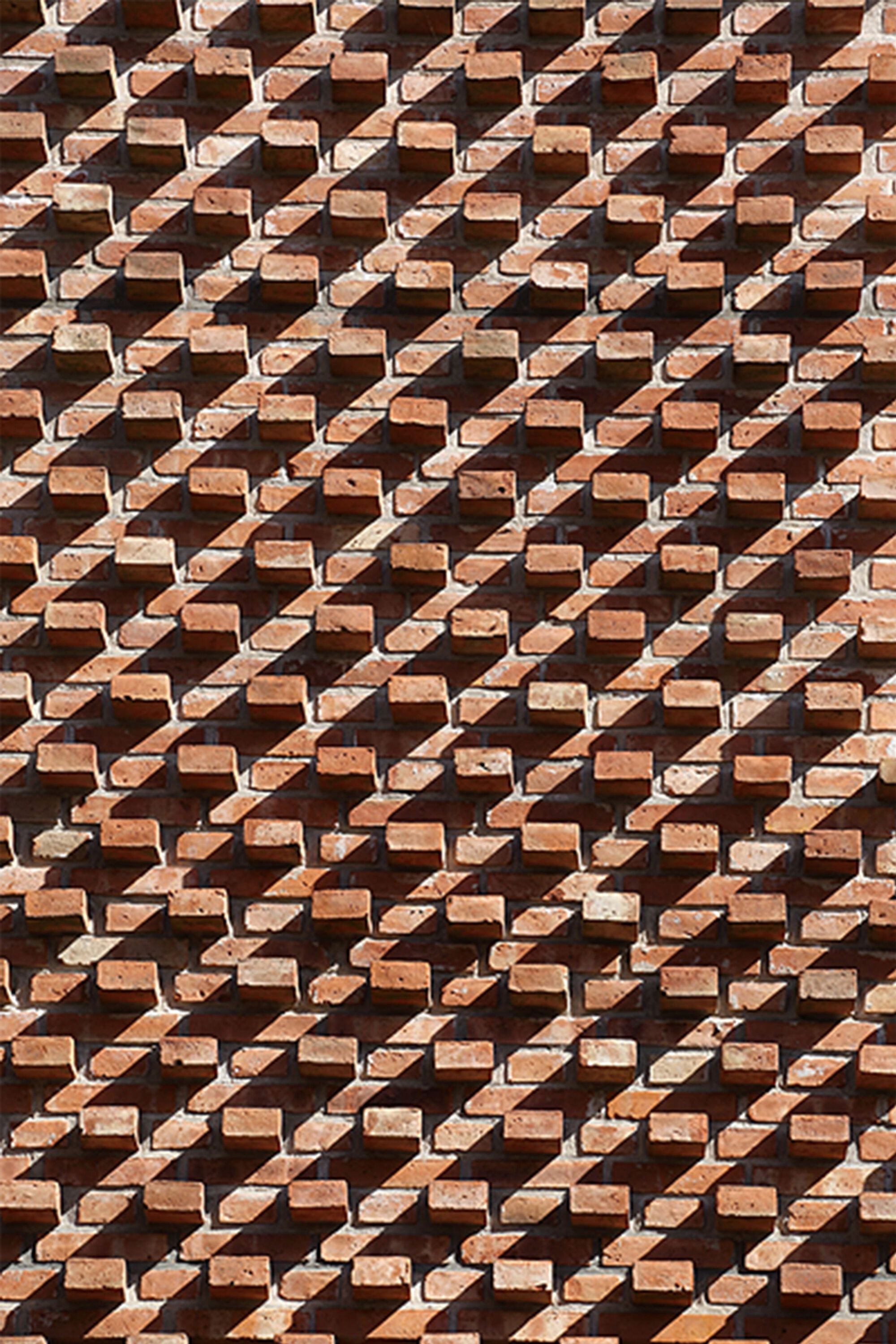 Close-up of the three-dimensional brick screen pattern creating deep diagonal shadows