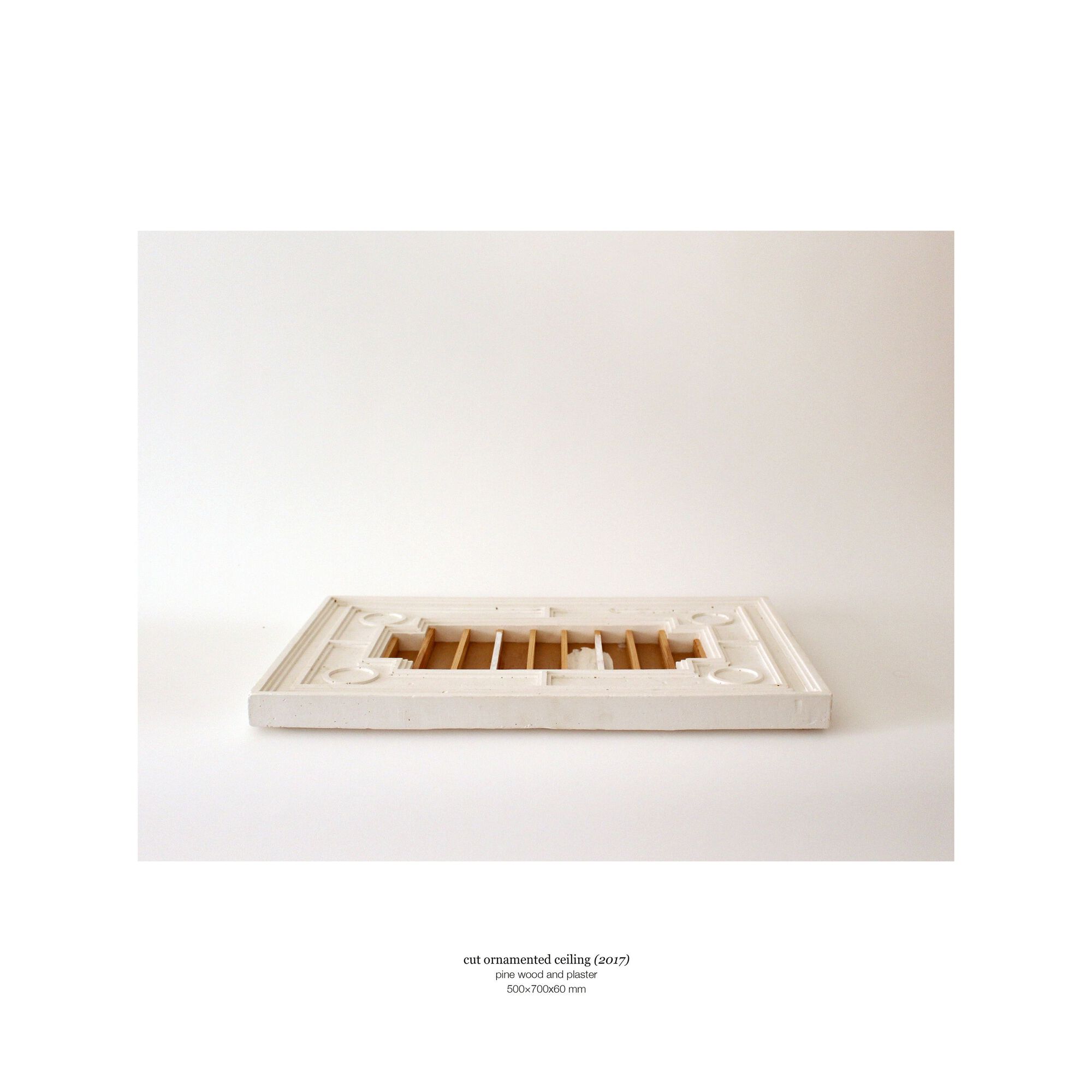 Physical sectional model showing the interior spatial organization and ceiling coffers under neutral studio lighting