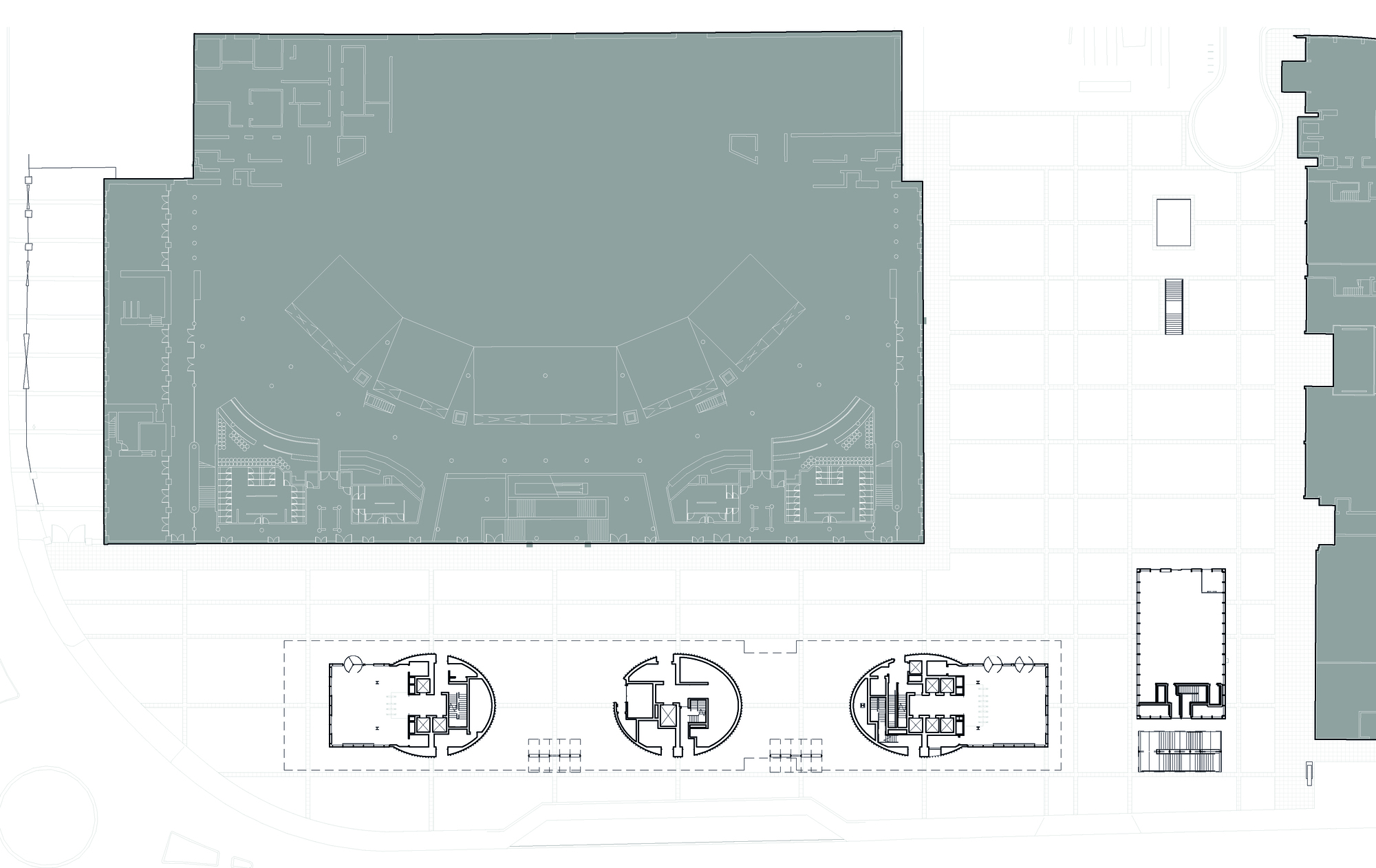 Floor plan drawing showing a curved atrium space above a ground floor with service cores
