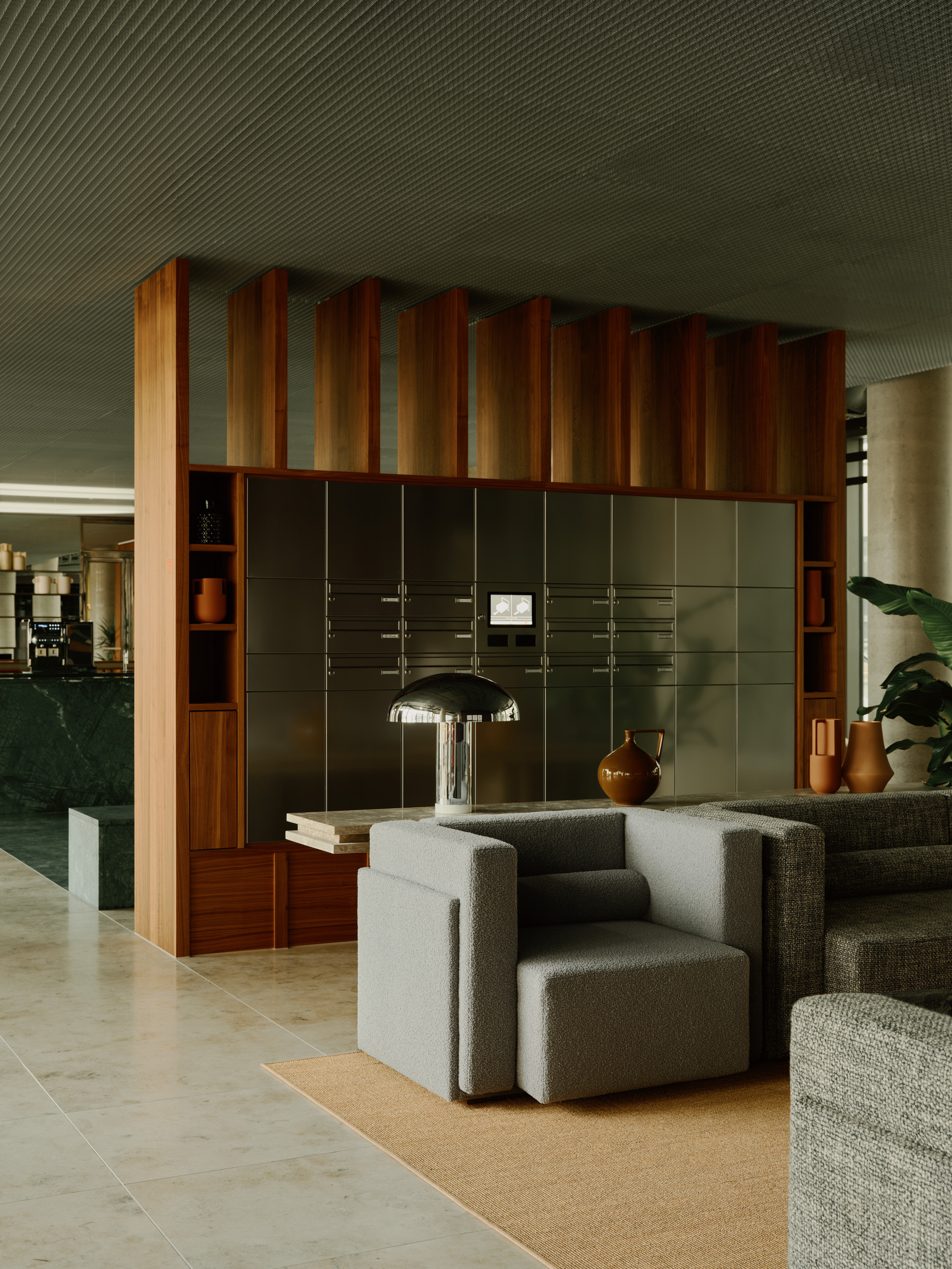 Lounge seating cluster beside a timber and olive panel storage wall under a slatted ceiling