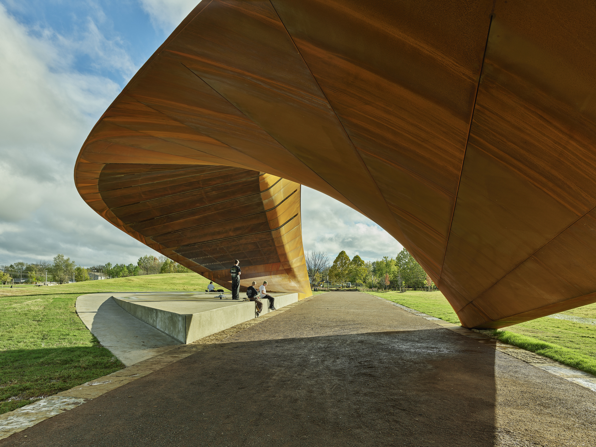 Underside of the warped steel panels and structural ribs viewed from beneath the canopy opening