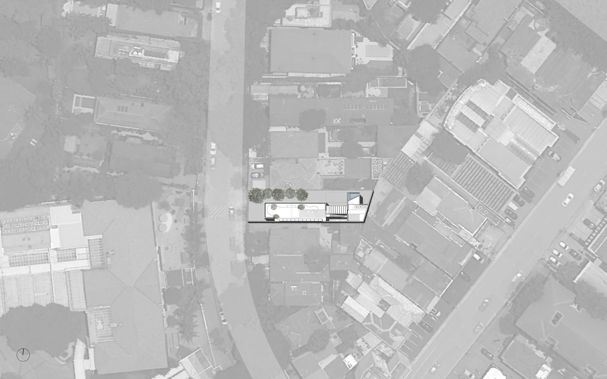 Aerial site plan drawing showing rectangular building footprint with courtyard and tree canopies within dense urban fabric