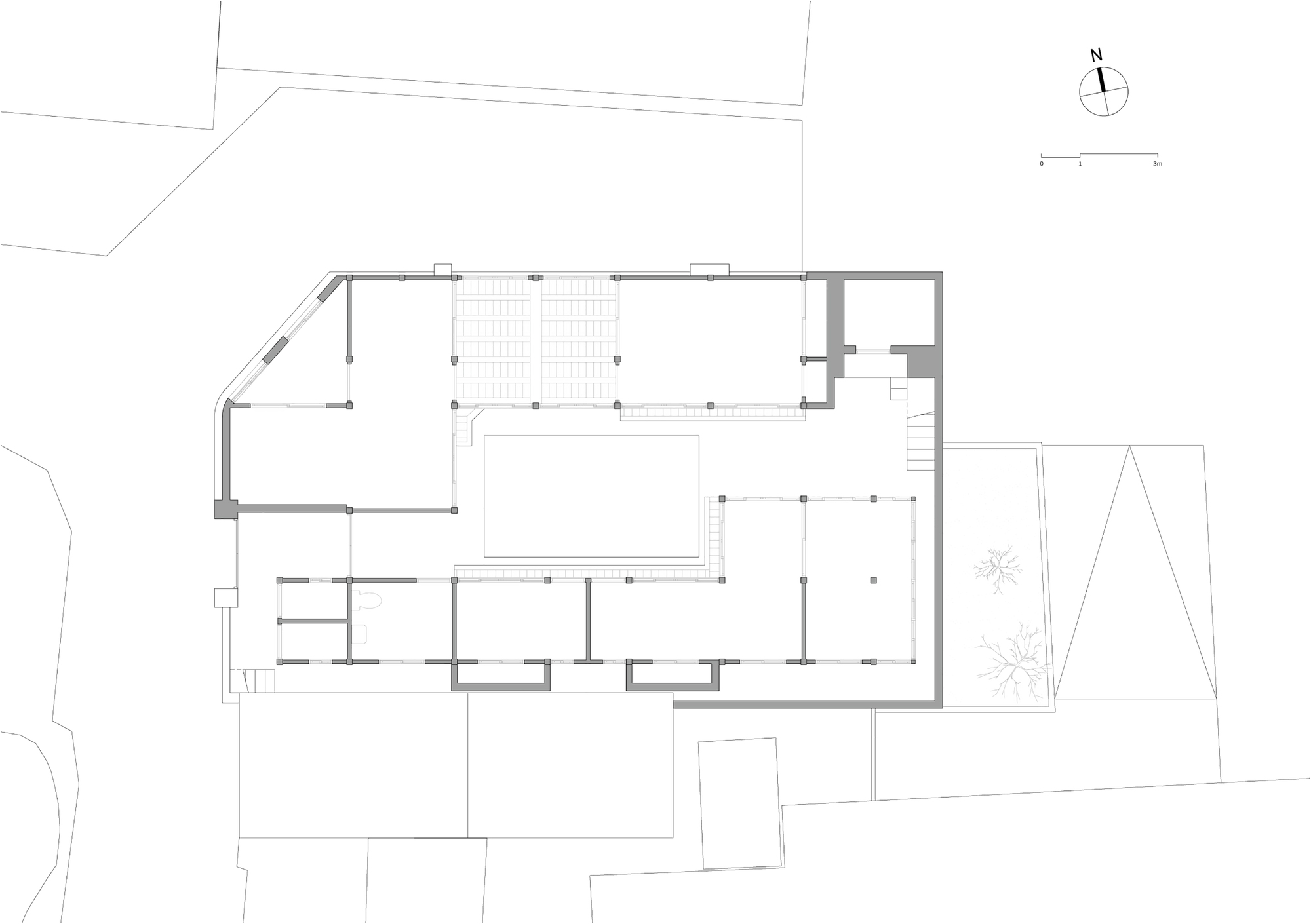 Floor plan drawing showing an L-shaped layout with a central courtyard and multiple rooms
