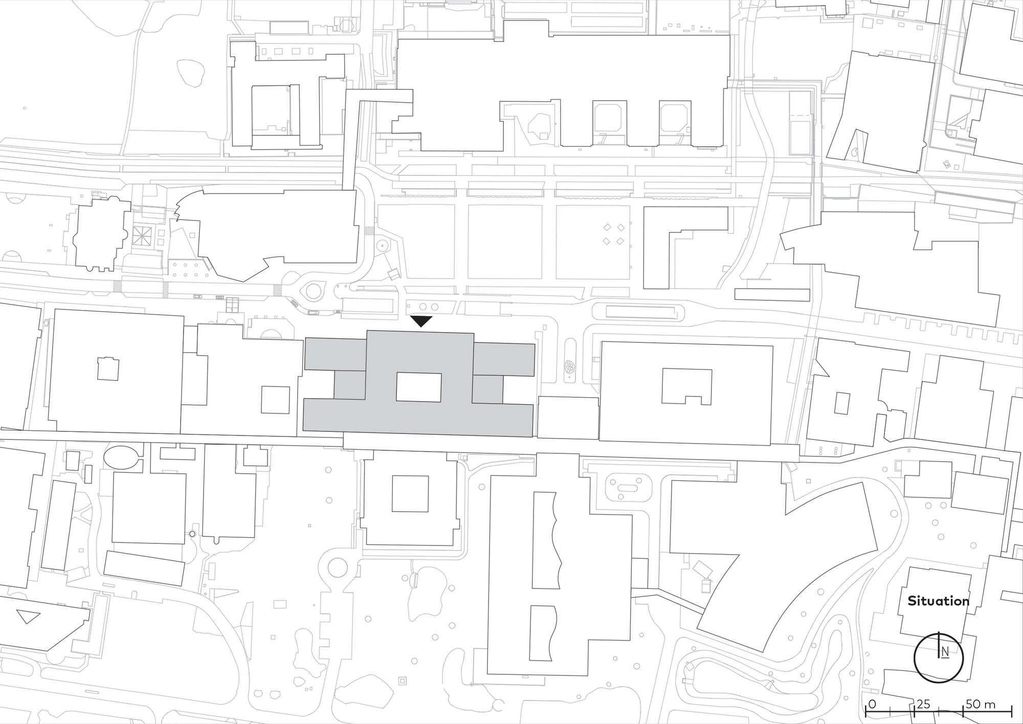 Site plan drawing situating three linked volumes within the surrounding urban fabric
