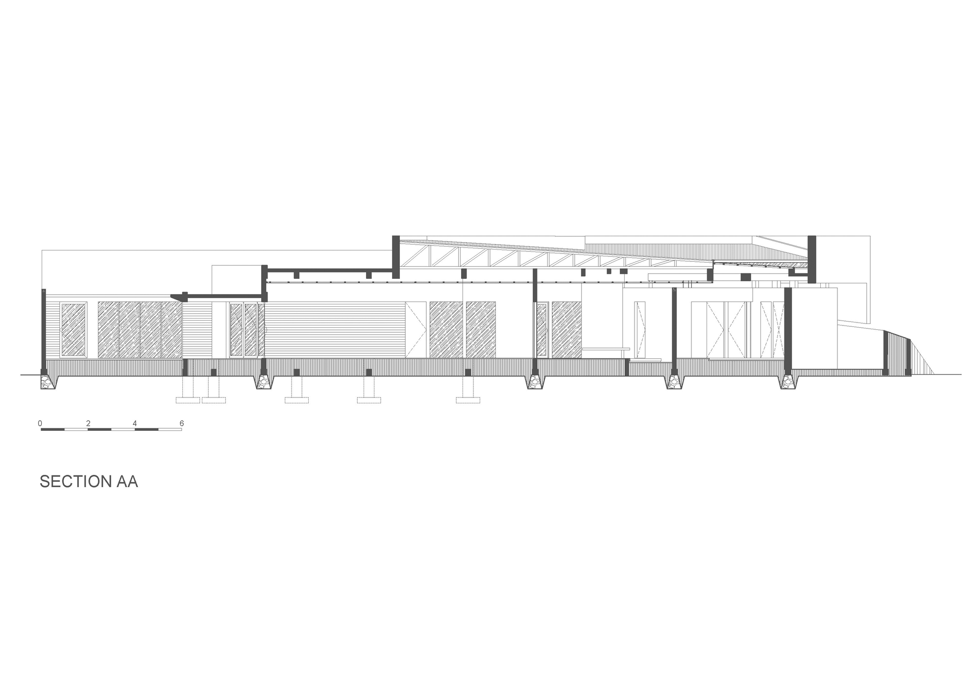 Section drawing showing the single-story structure with exposed roof trusses and column supports