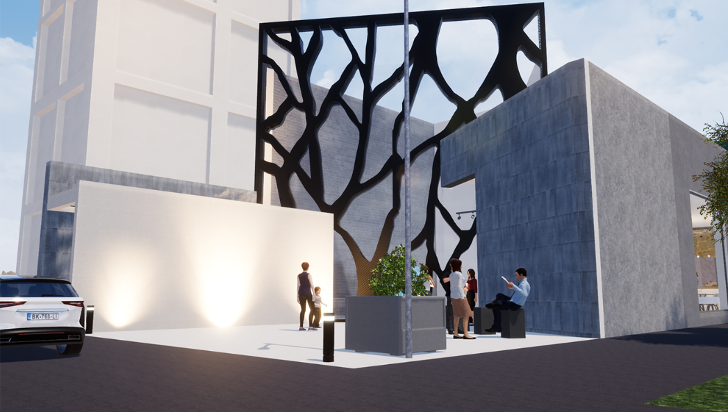 Street-level view showing SCAR’s concrete volumes, illuminated entry, and expressive façade as a memory marker.