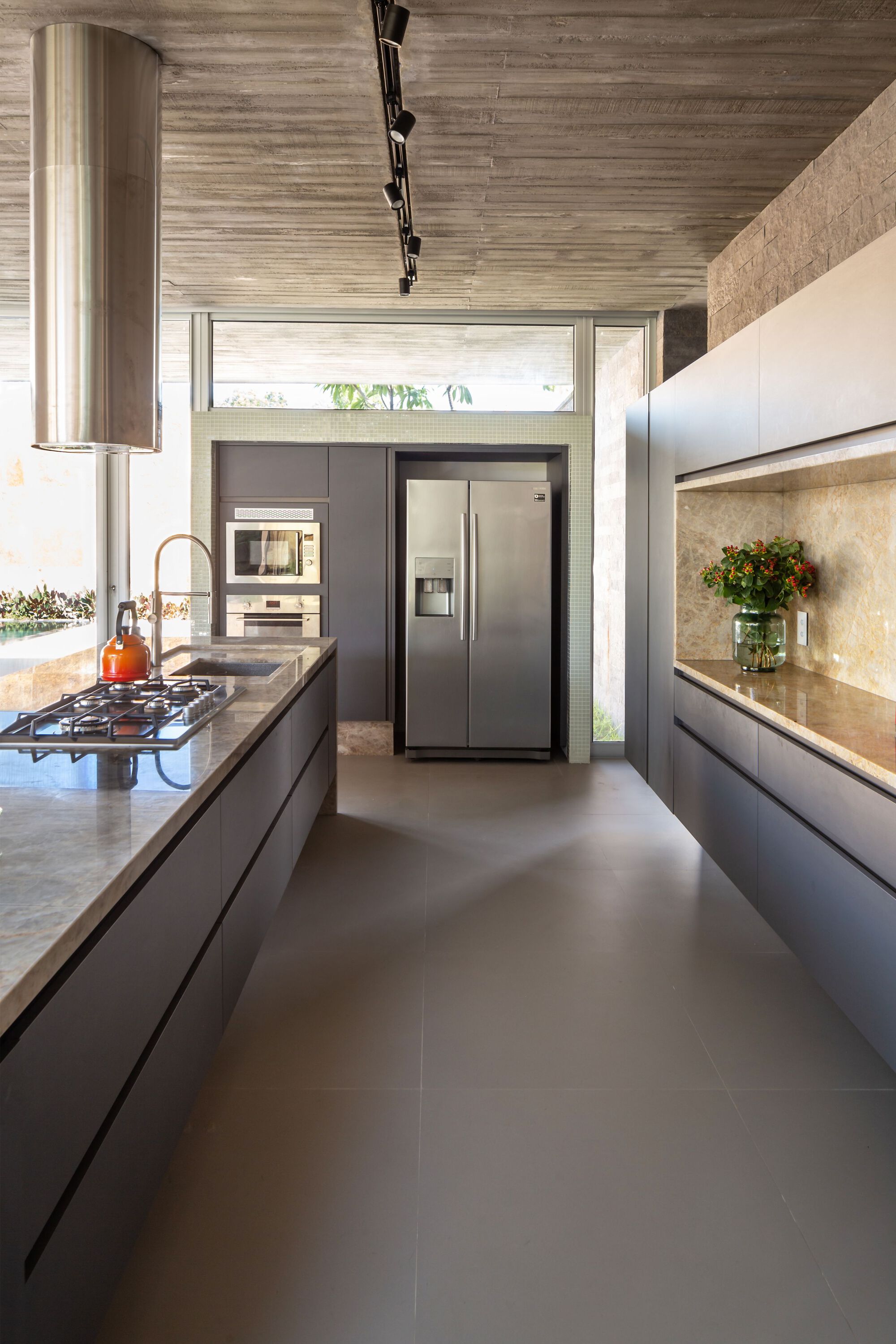 Kitchen with striped timber ceiling, dark cabinetry, and clerestory windows bringing in natural light