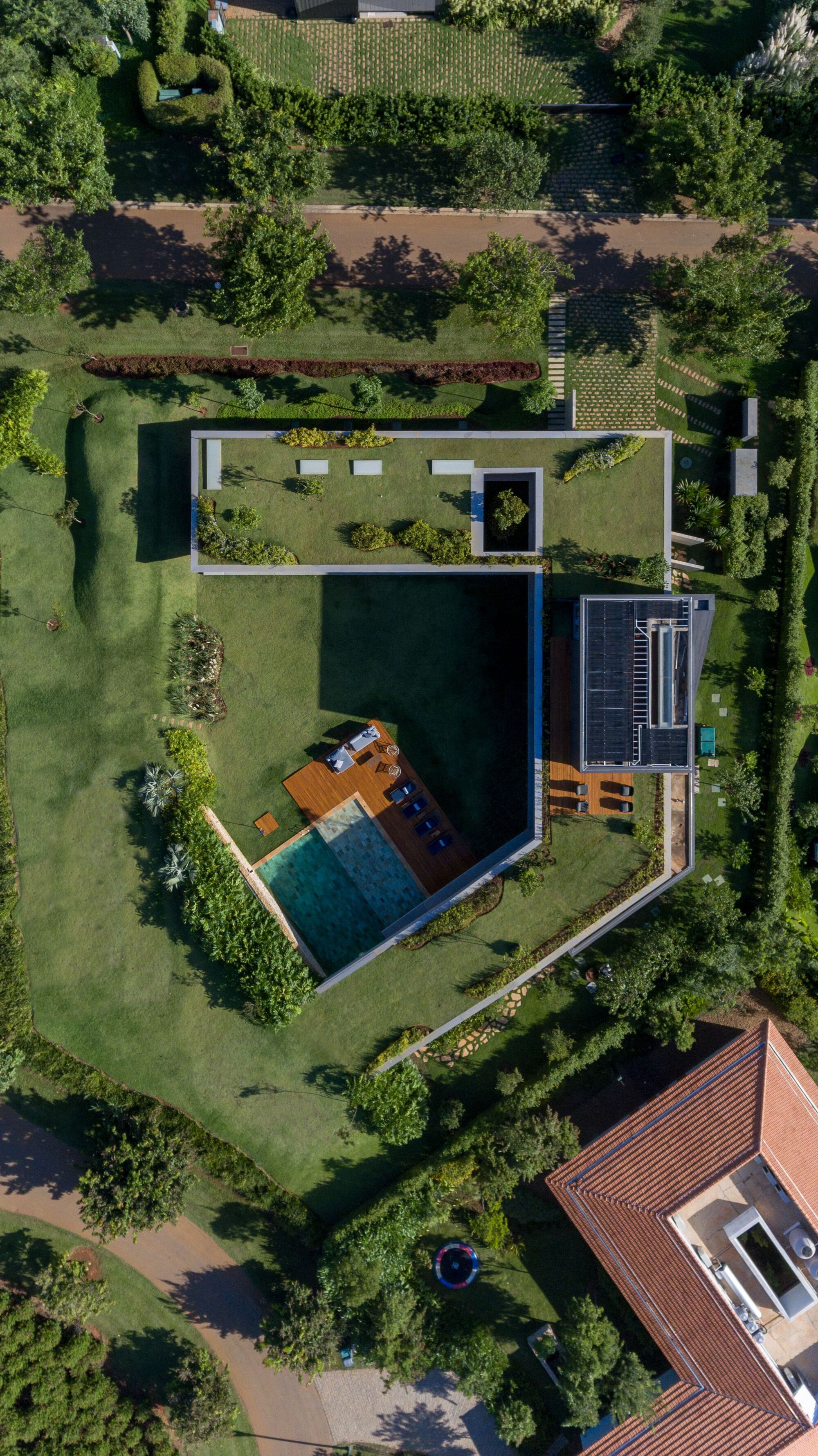 Aerial view of the green roof and central courtyard with pool surrounded by lawn and trees