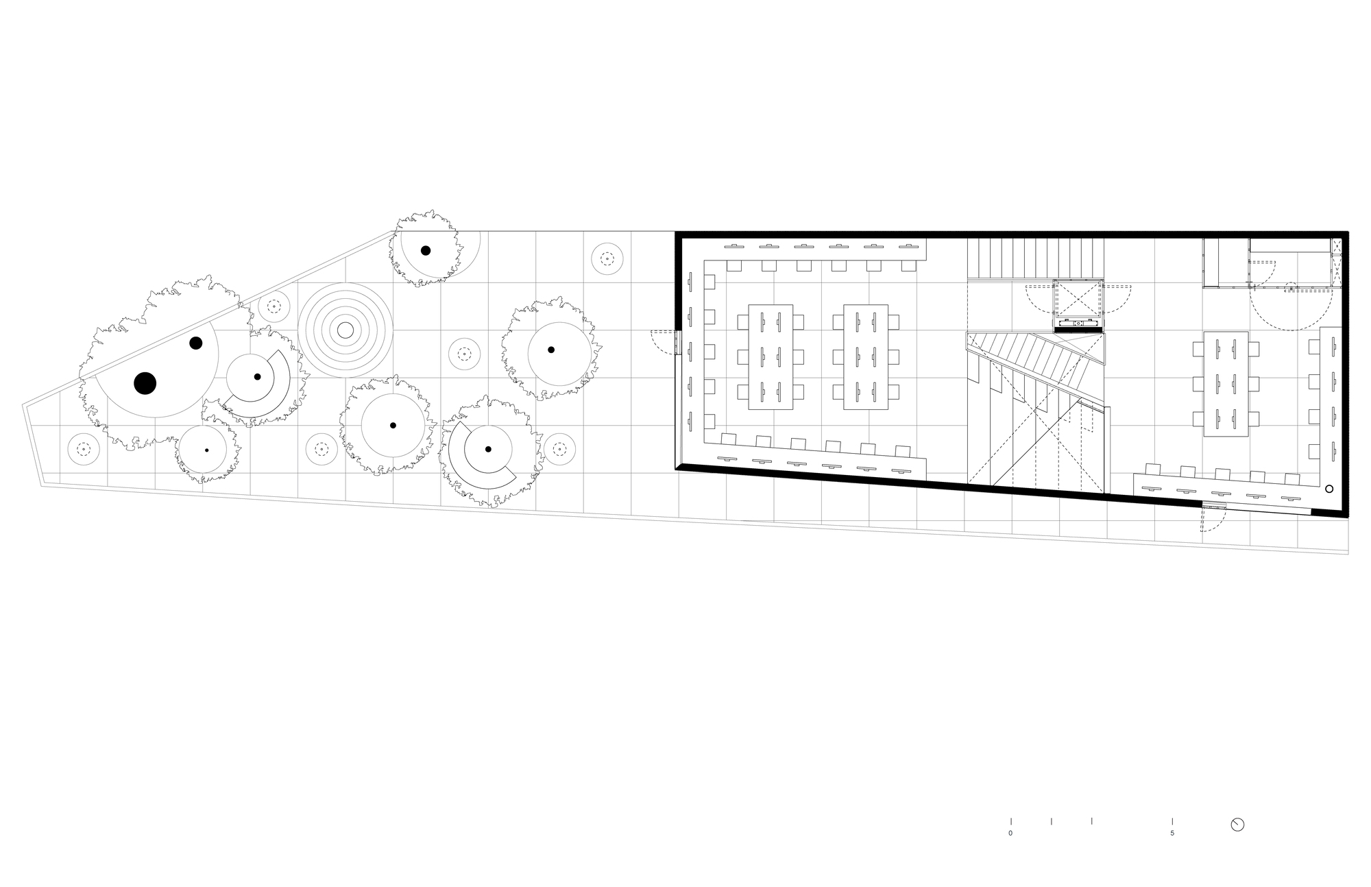 Ground floor plan showing workspaces flanking a central staircase with tree-lined courtyard to the left