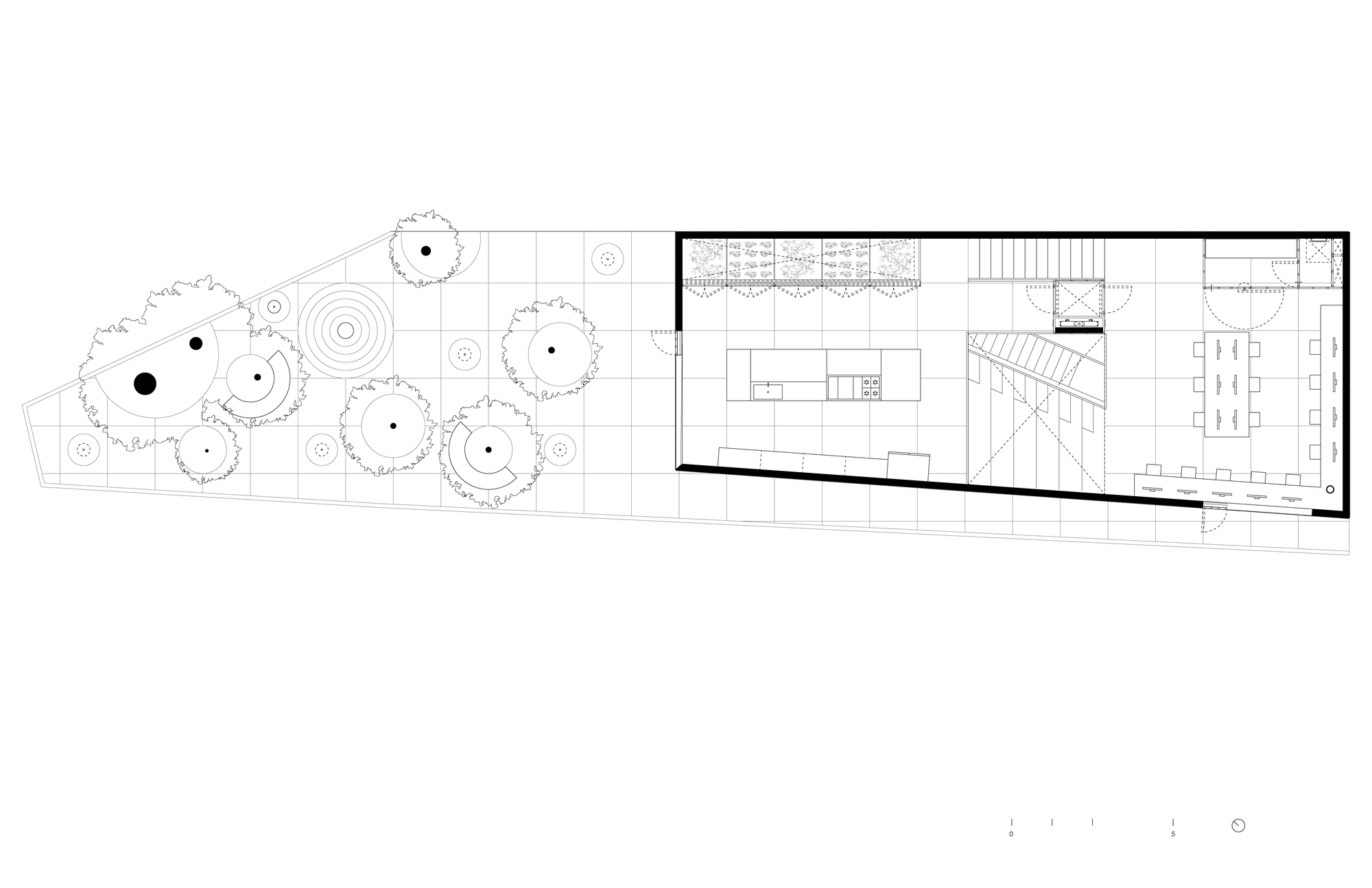 First floor plan showing open kitchen and living areas with staircase and adjacent courtyard garden