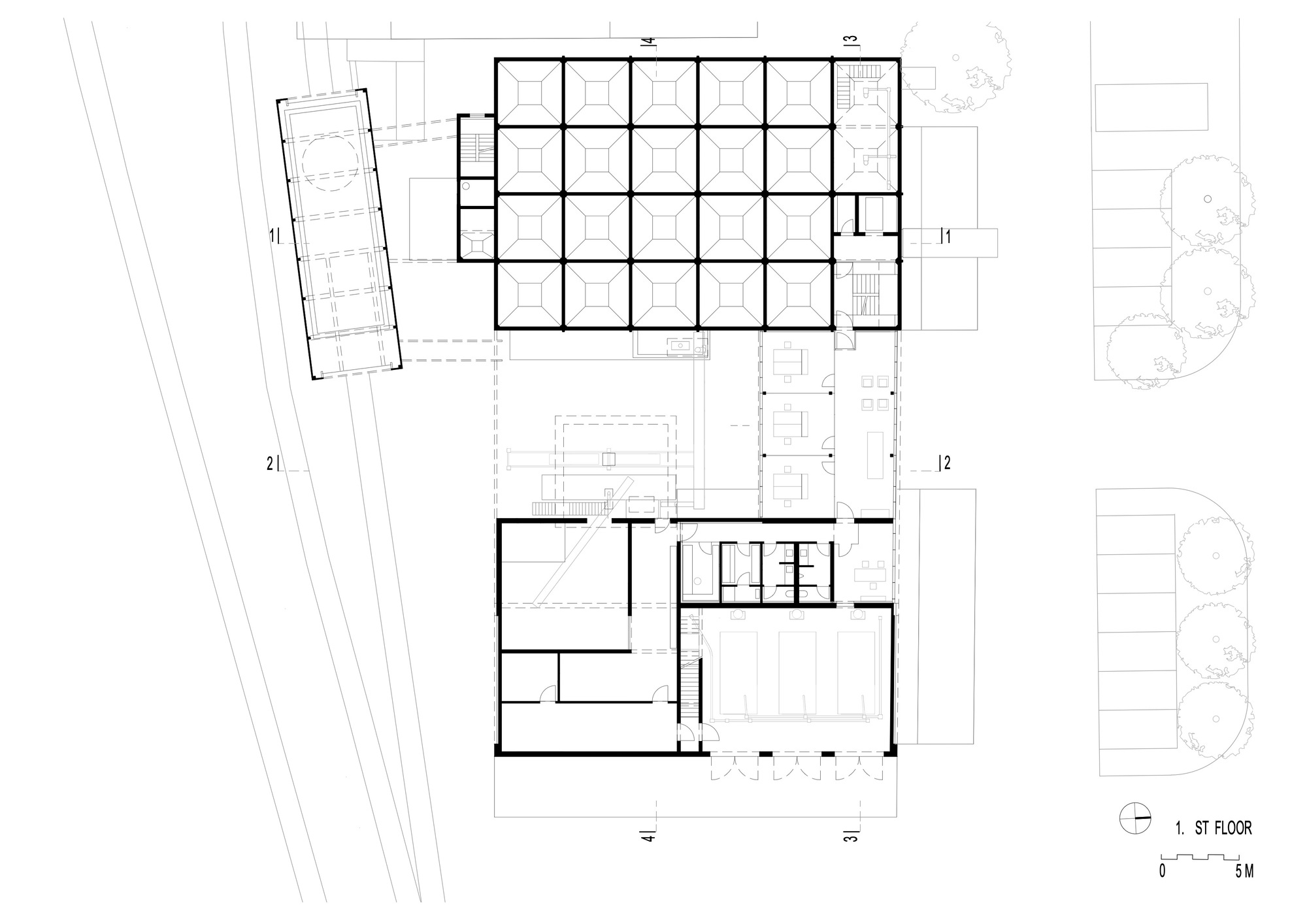 First floor plan drawing showing gridded workspace, loading area, and support rooms