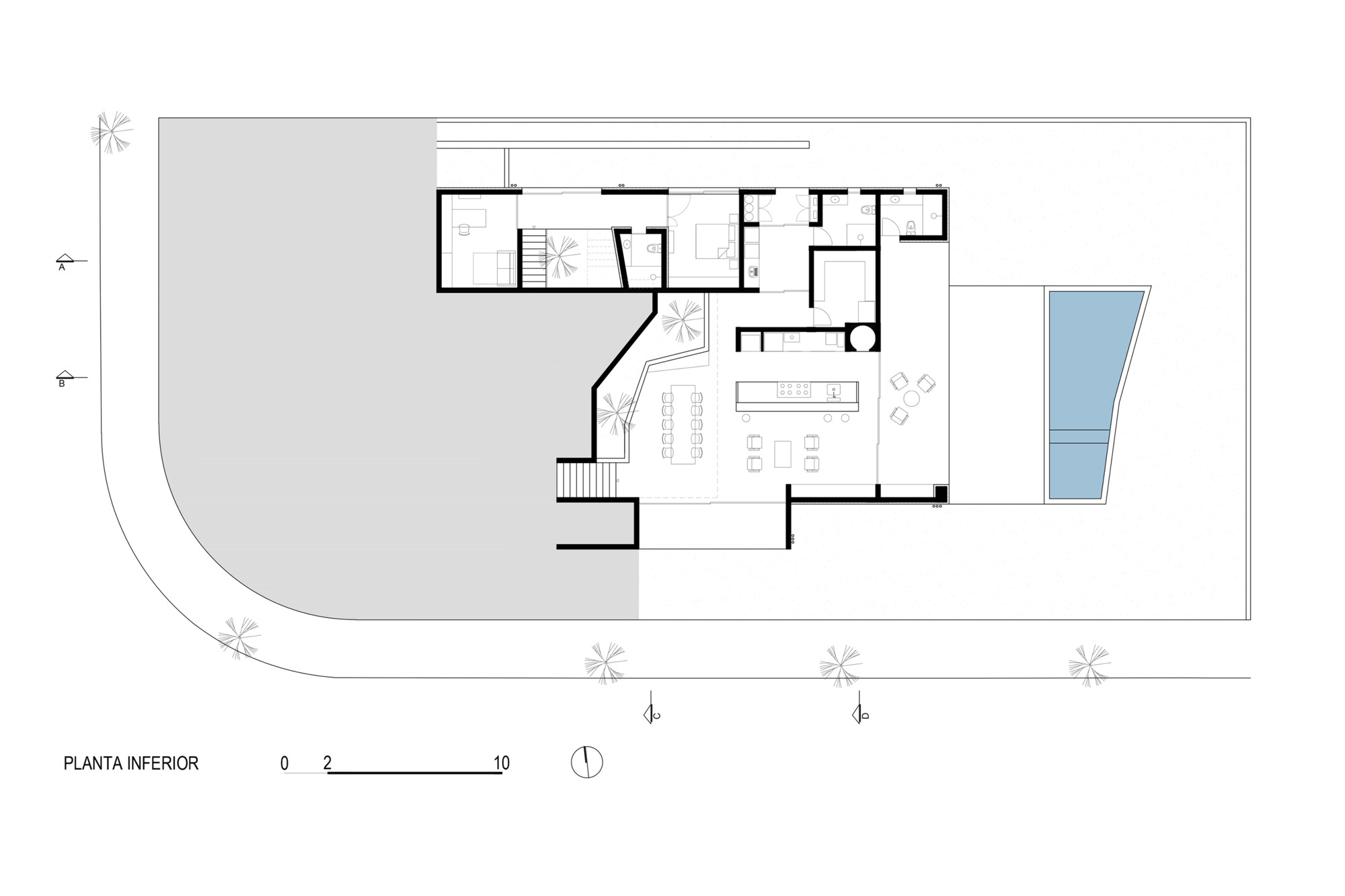 Ground floor plan drawing showing open living areas and angled circulation path adjacent to pool