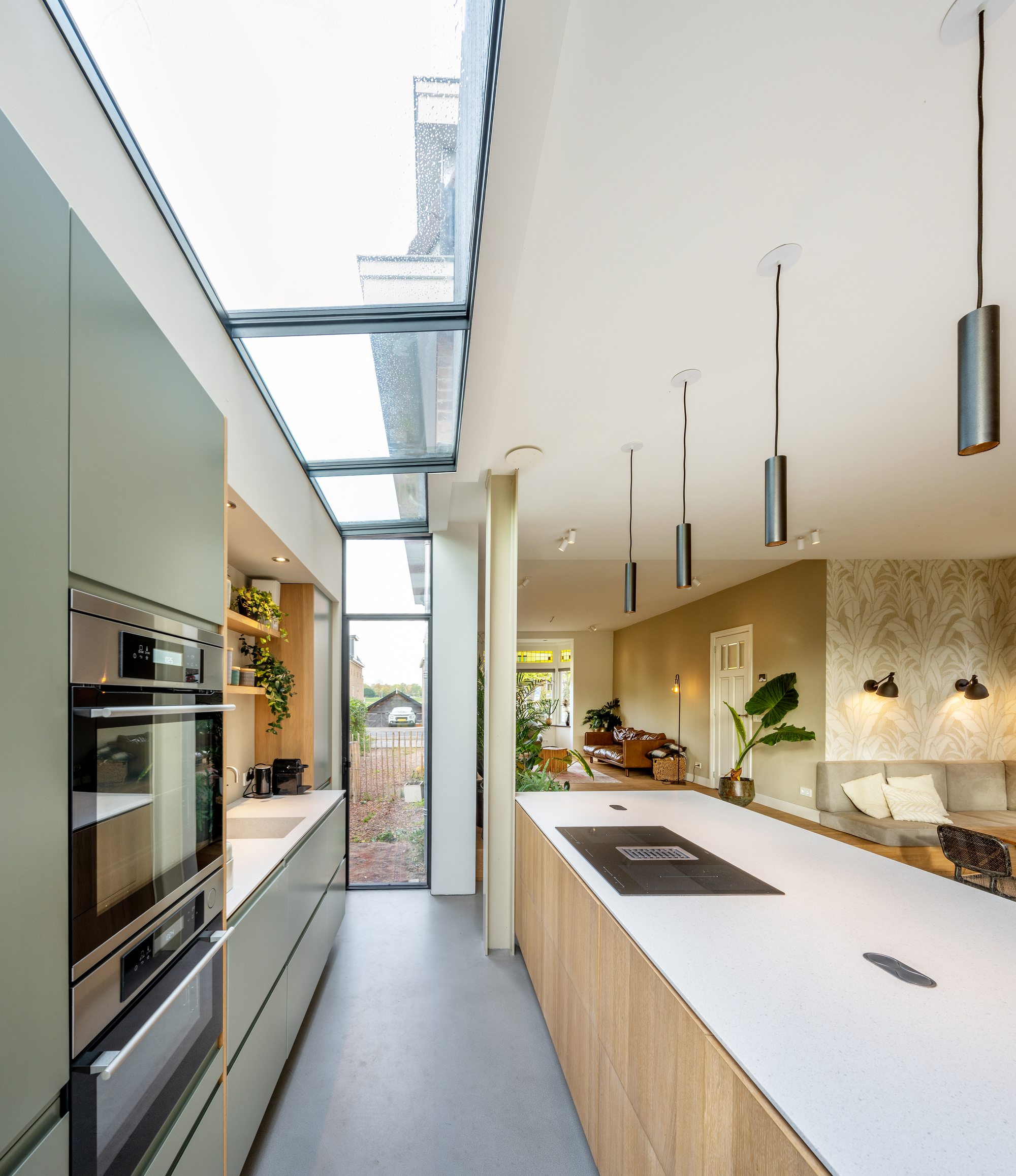 Galley kitchen with continuous skylights running along the length of the narrow space