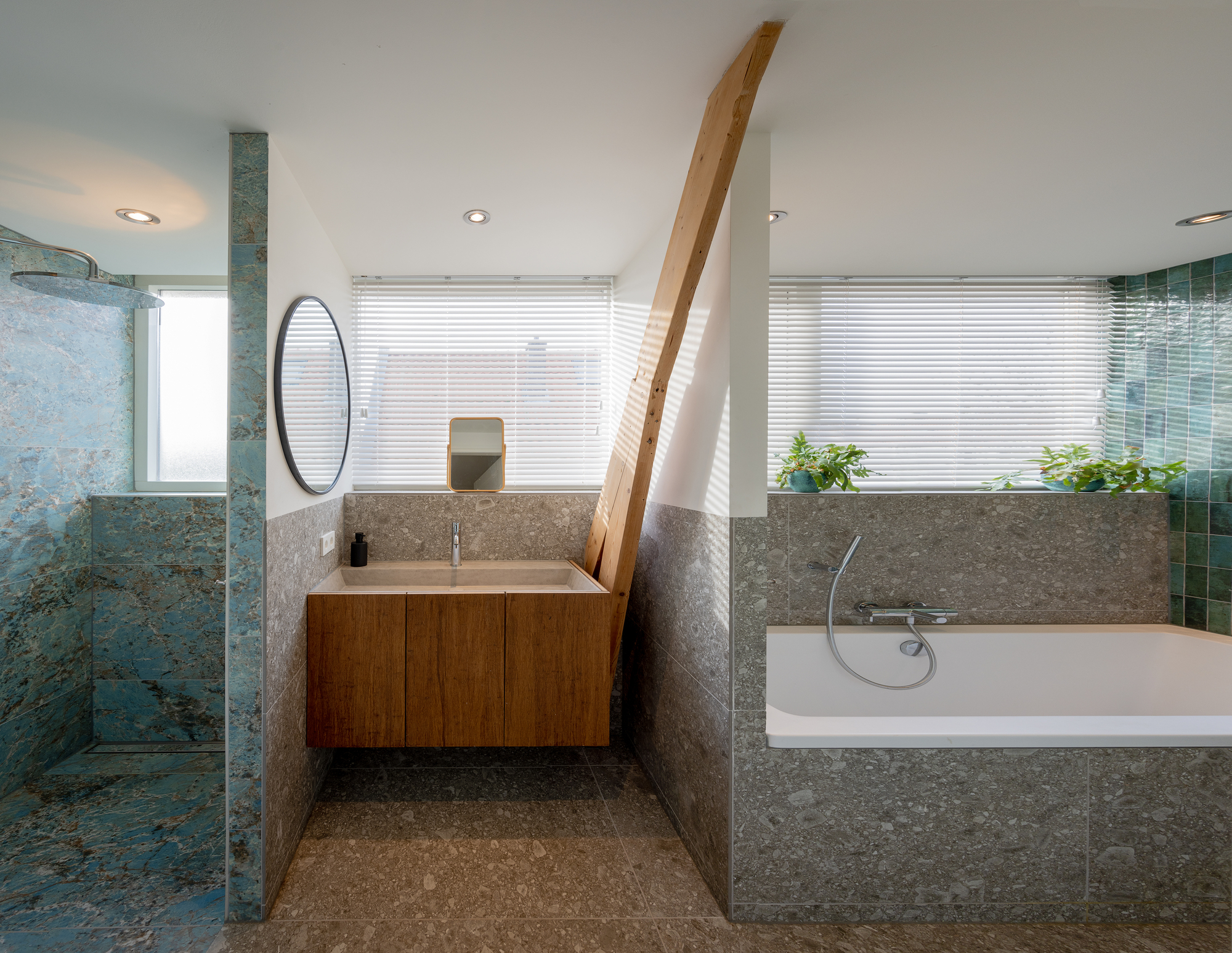 Bathroom with exposed timber beam, terrazzo wall cladding and tiled shower enclosure with horizontal blinds