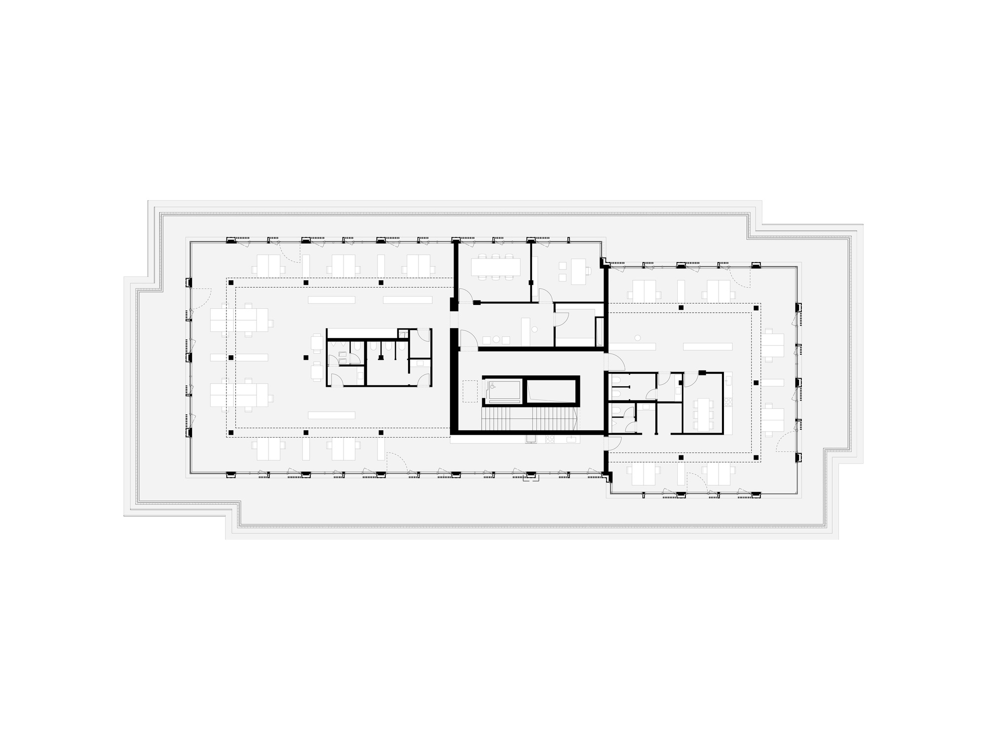 Floor plan drawing depicting an open workspace with central core and enclosed rooms along the perimeter