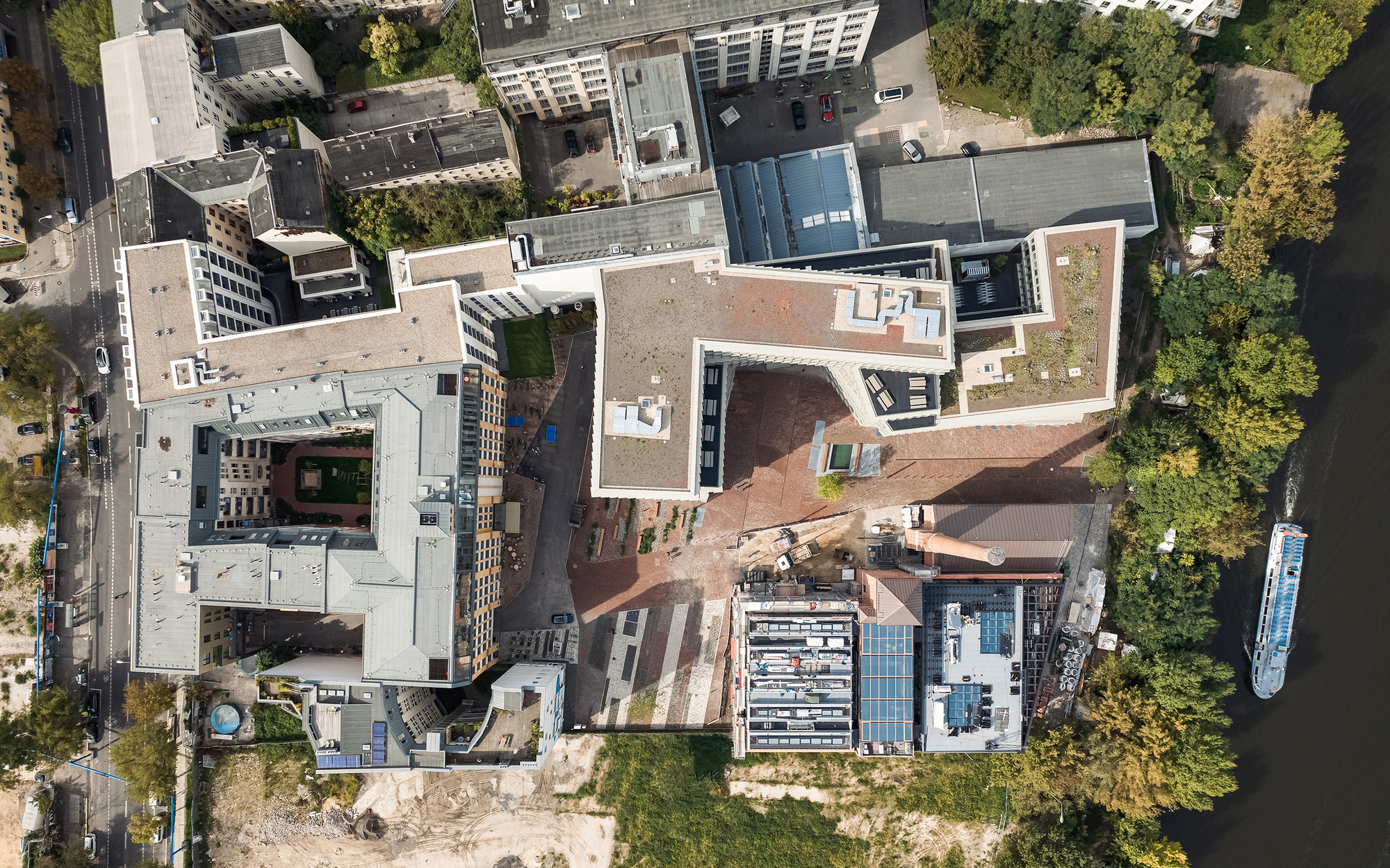 Aerial view of the terracotta roof courtyard surrounded by mixed development in summer