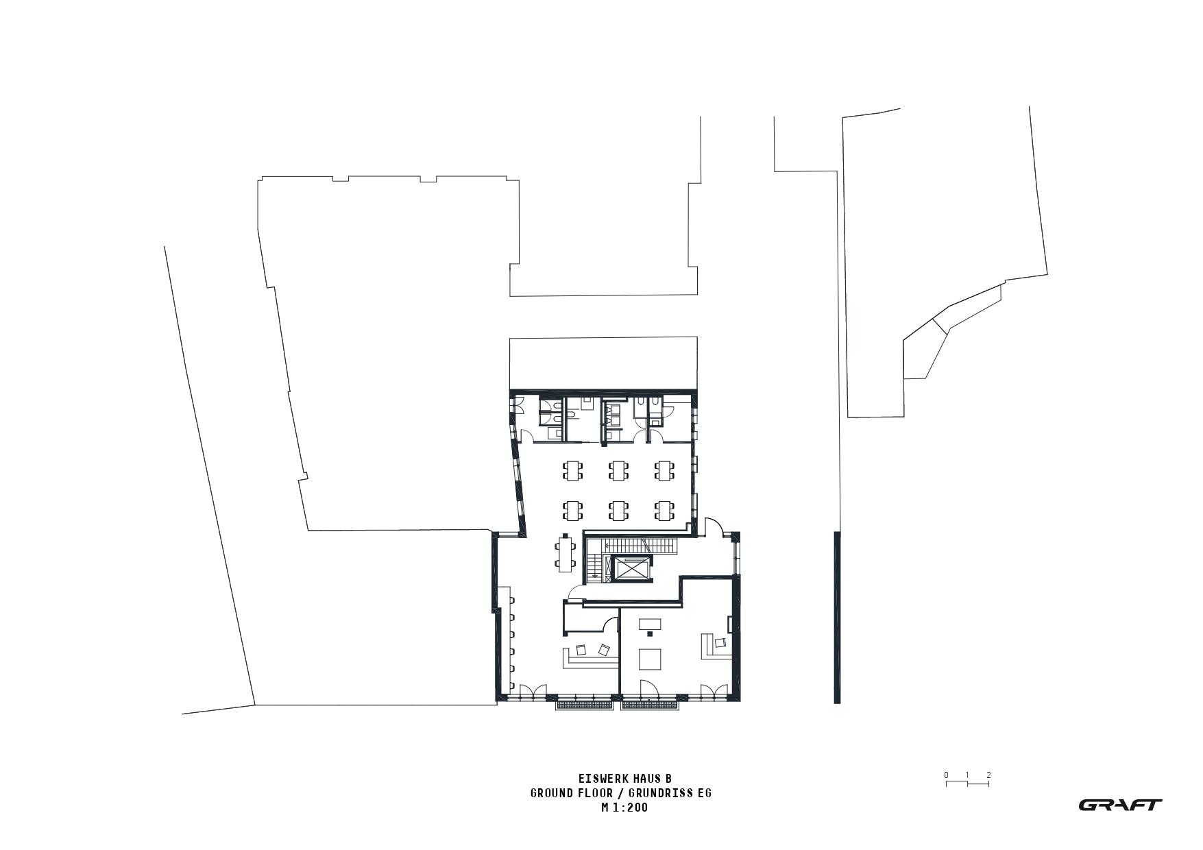 Ground floor plan drawing showing an open workspace with seating clusters and a central staircase