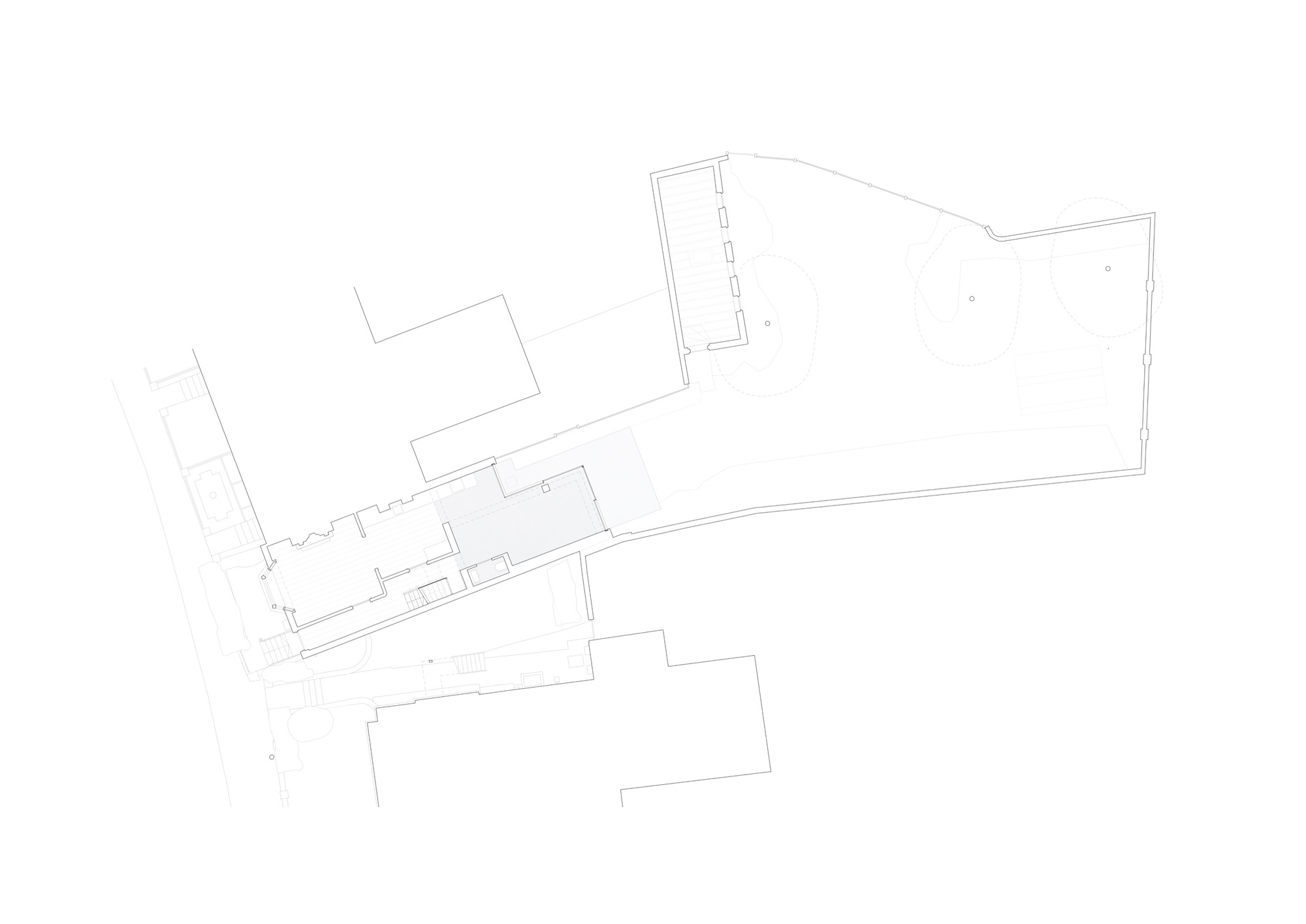 Floor plan showing an angular layout with central corridor connecting existing and new volumes