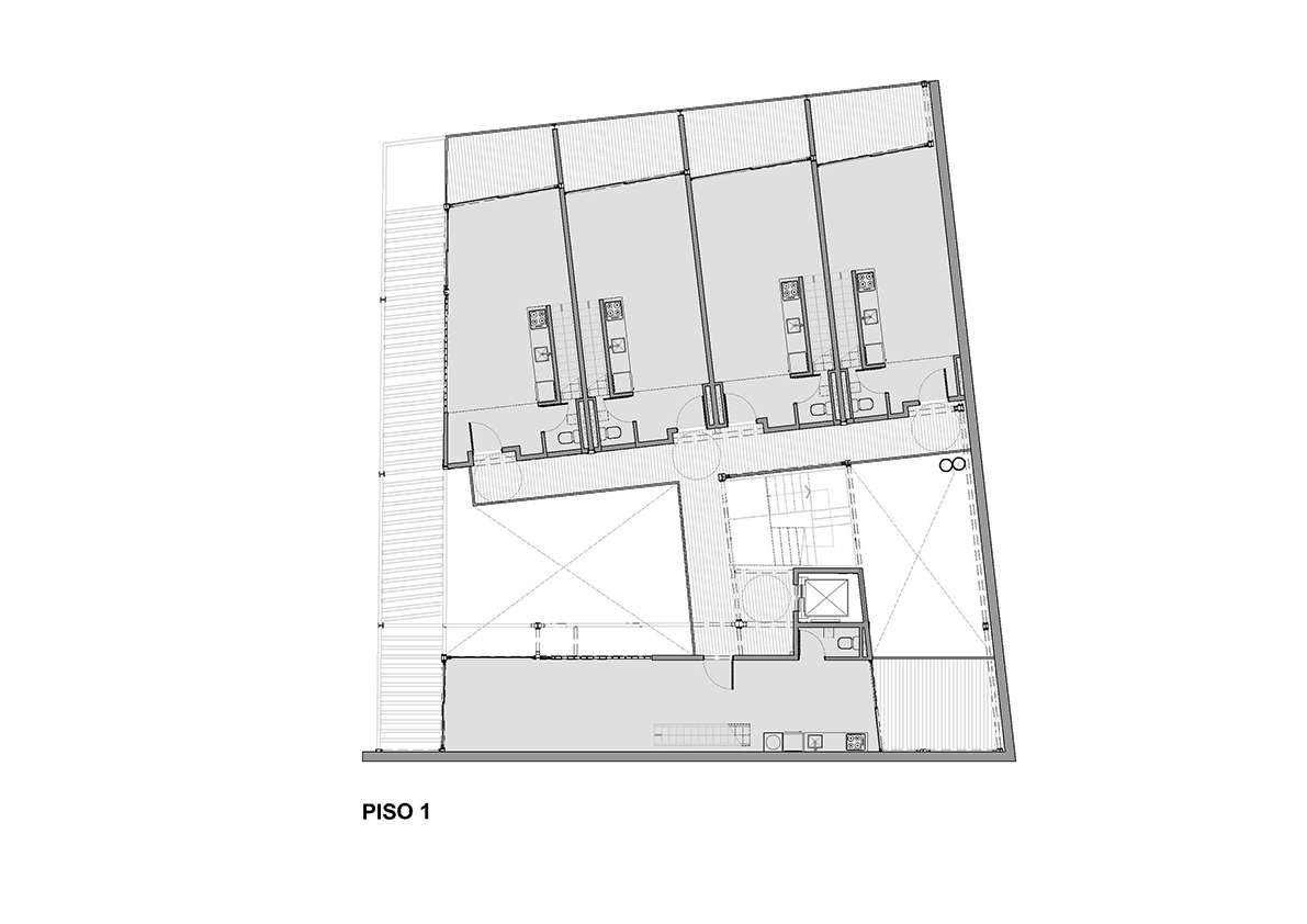 Floor plan drawing showing a first-floor layout with four rental units and a central stairwell core