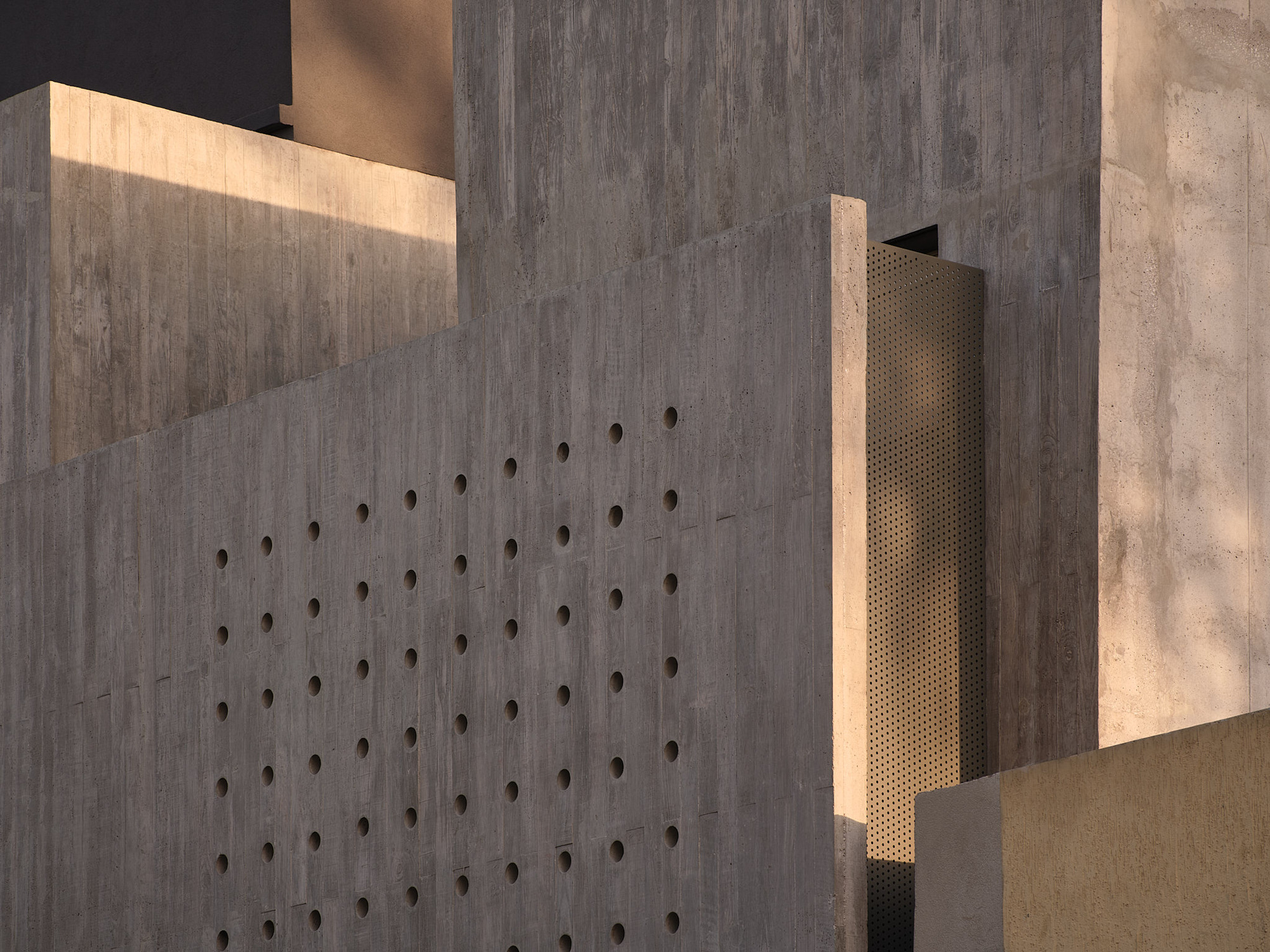 Board-formed concrete wall with dimpled tie holes illuminated by a recessed slot of warm light