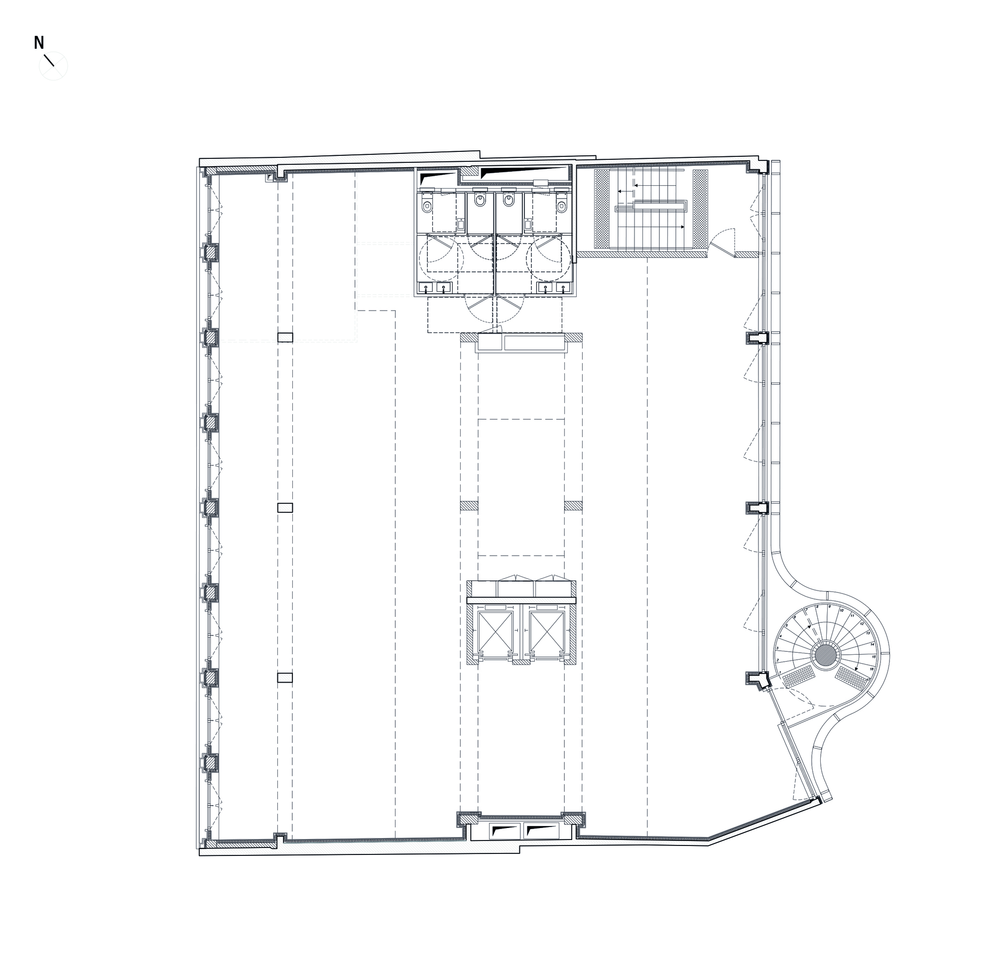 Floor plan drawing showing an open space with central restrooms, stair, and a curved corner staircase
