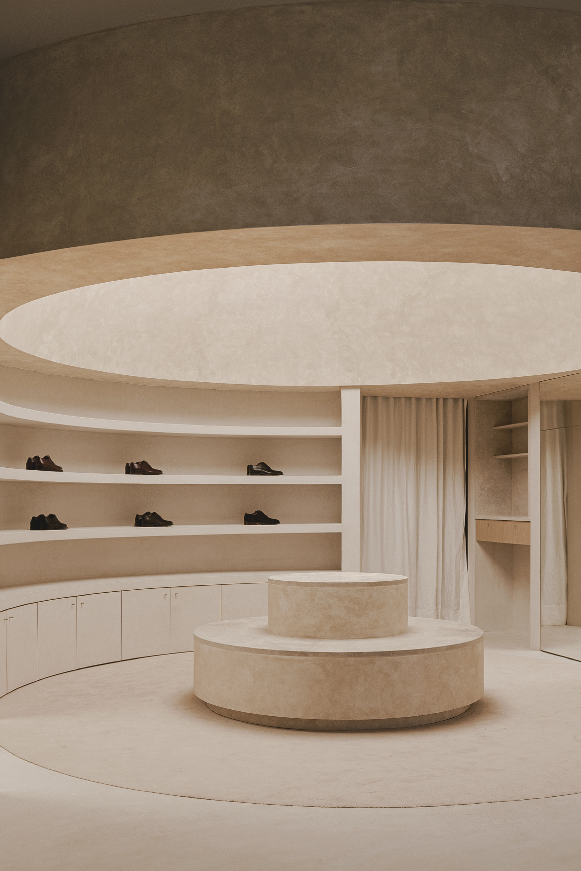 View of the tiered display podium beneath layered curved ceiling planes and a central oculus