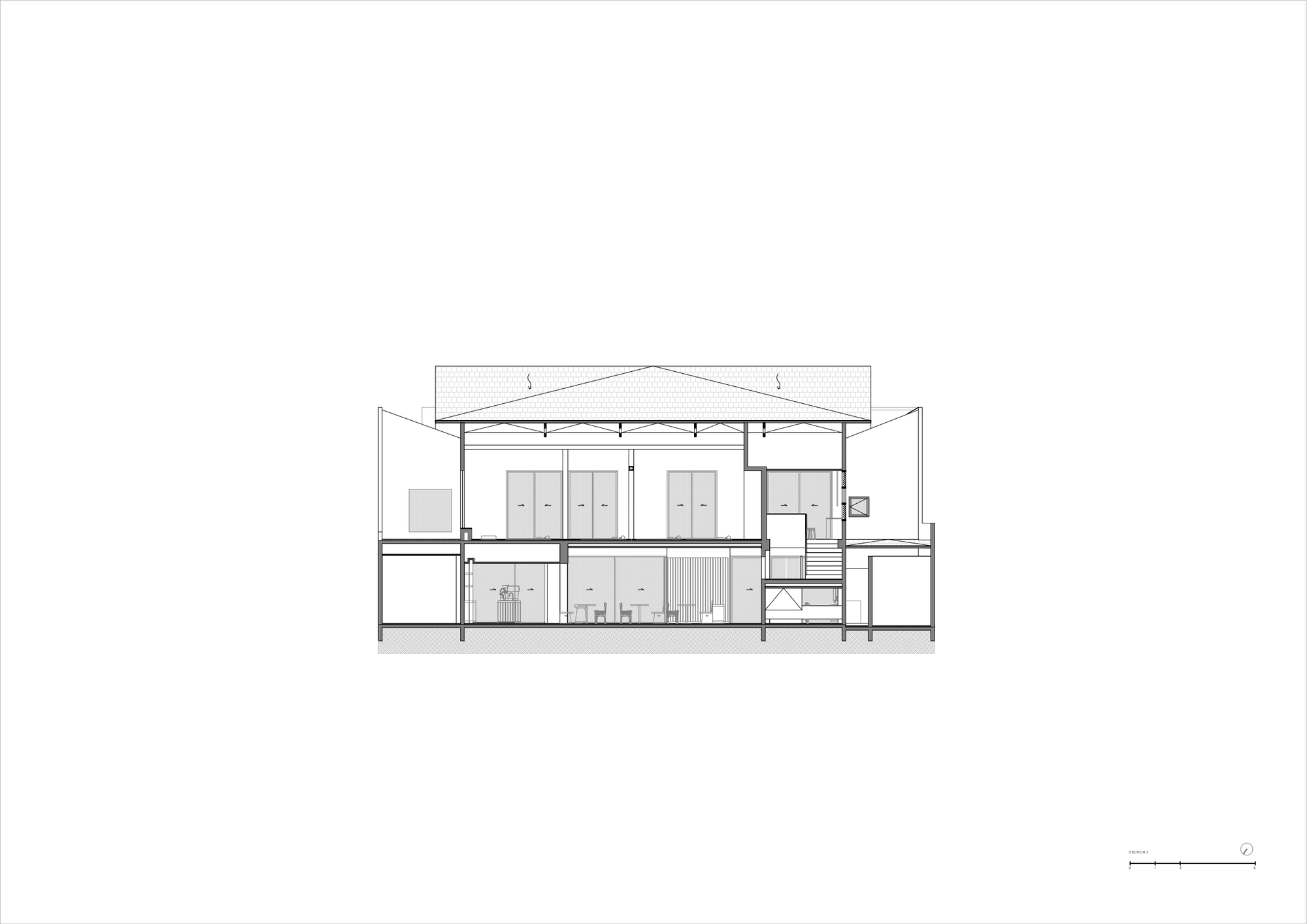 Section drawing revealing a two-story volume with exposed ceiling structure and interior partitions