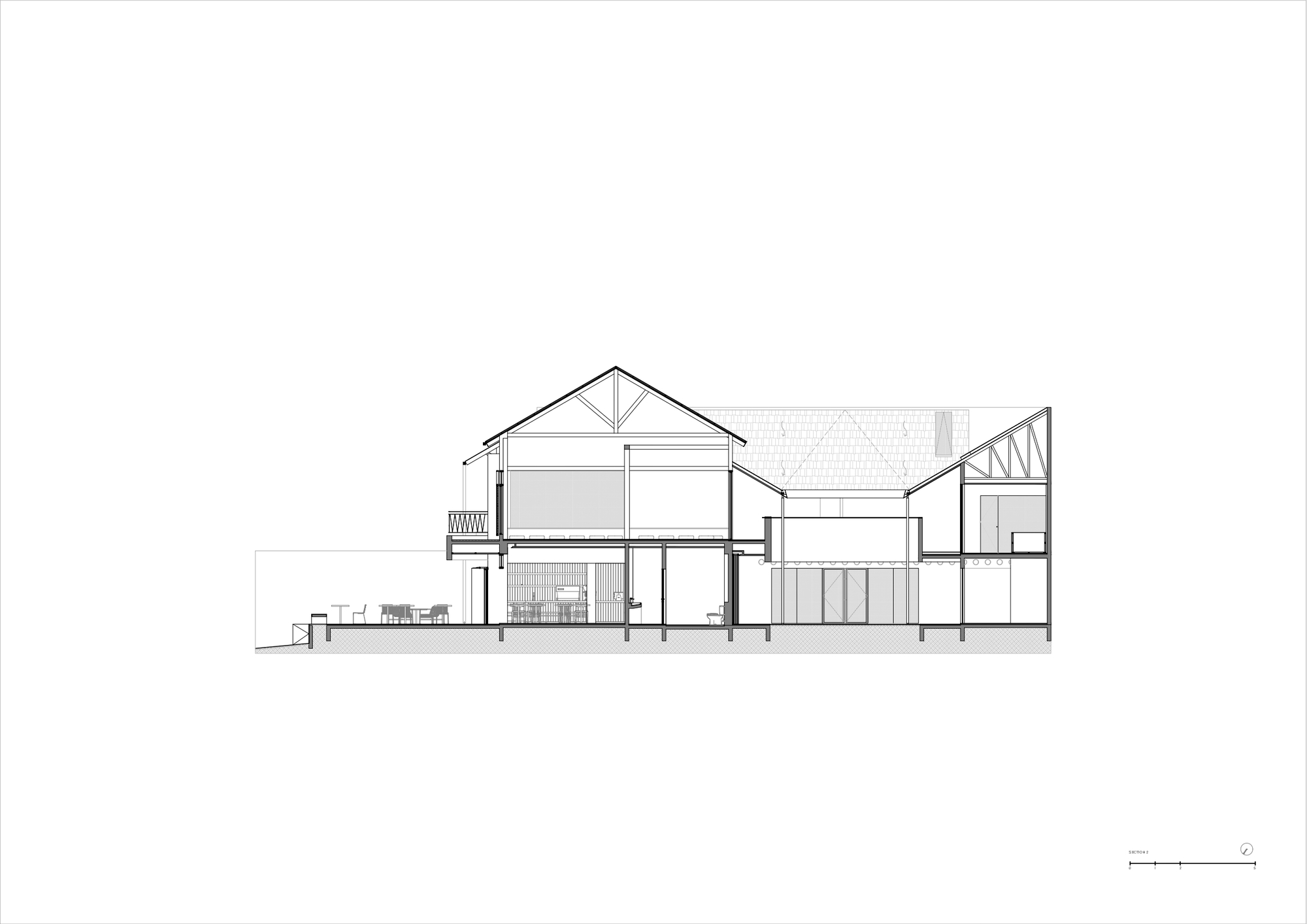 Section drawing depicting interconnected pitched roof forms with varying ceiling heights and interior furnishings