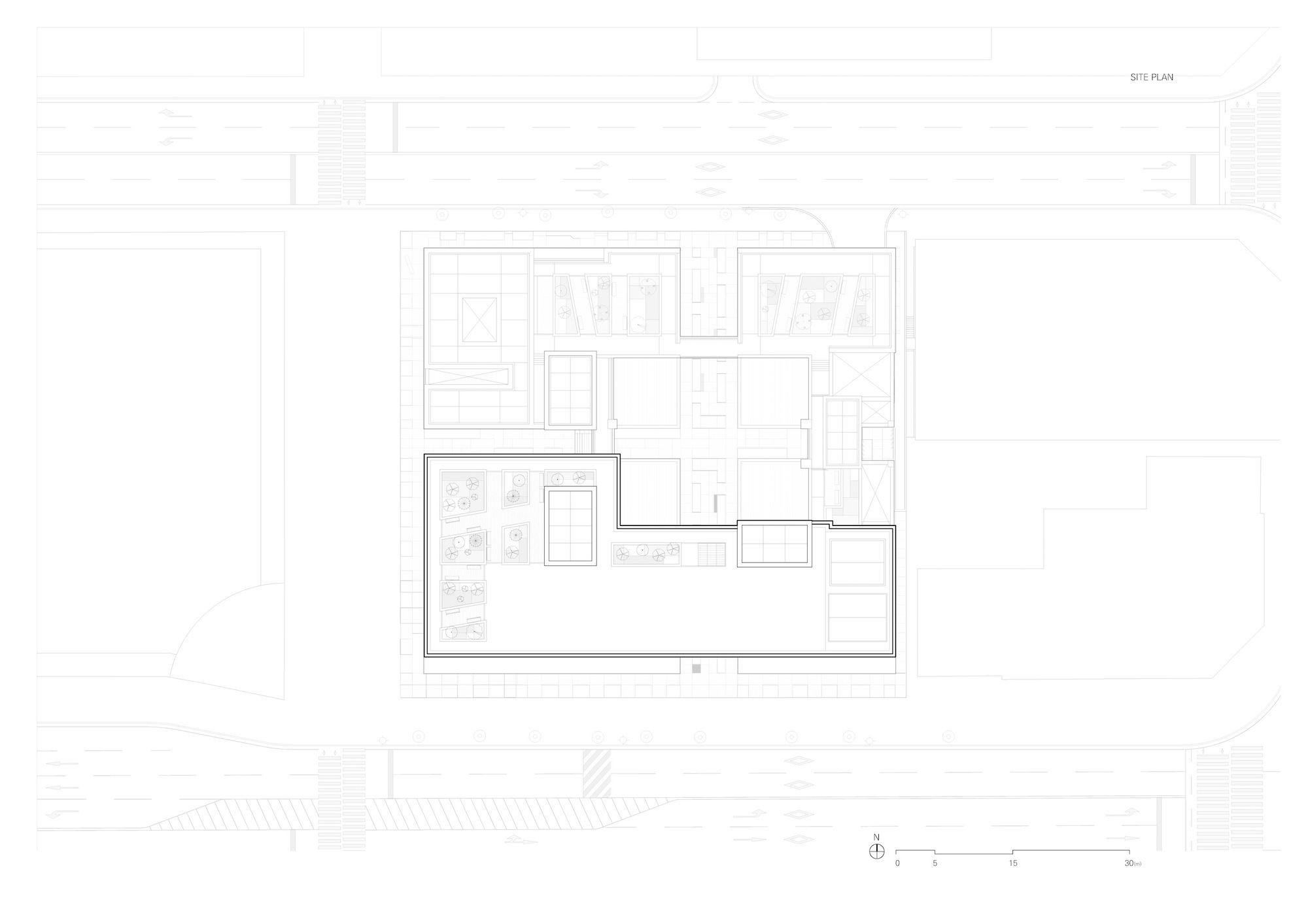Site plan drawing showing the building footprint with a central courtyard and surrounding street context
