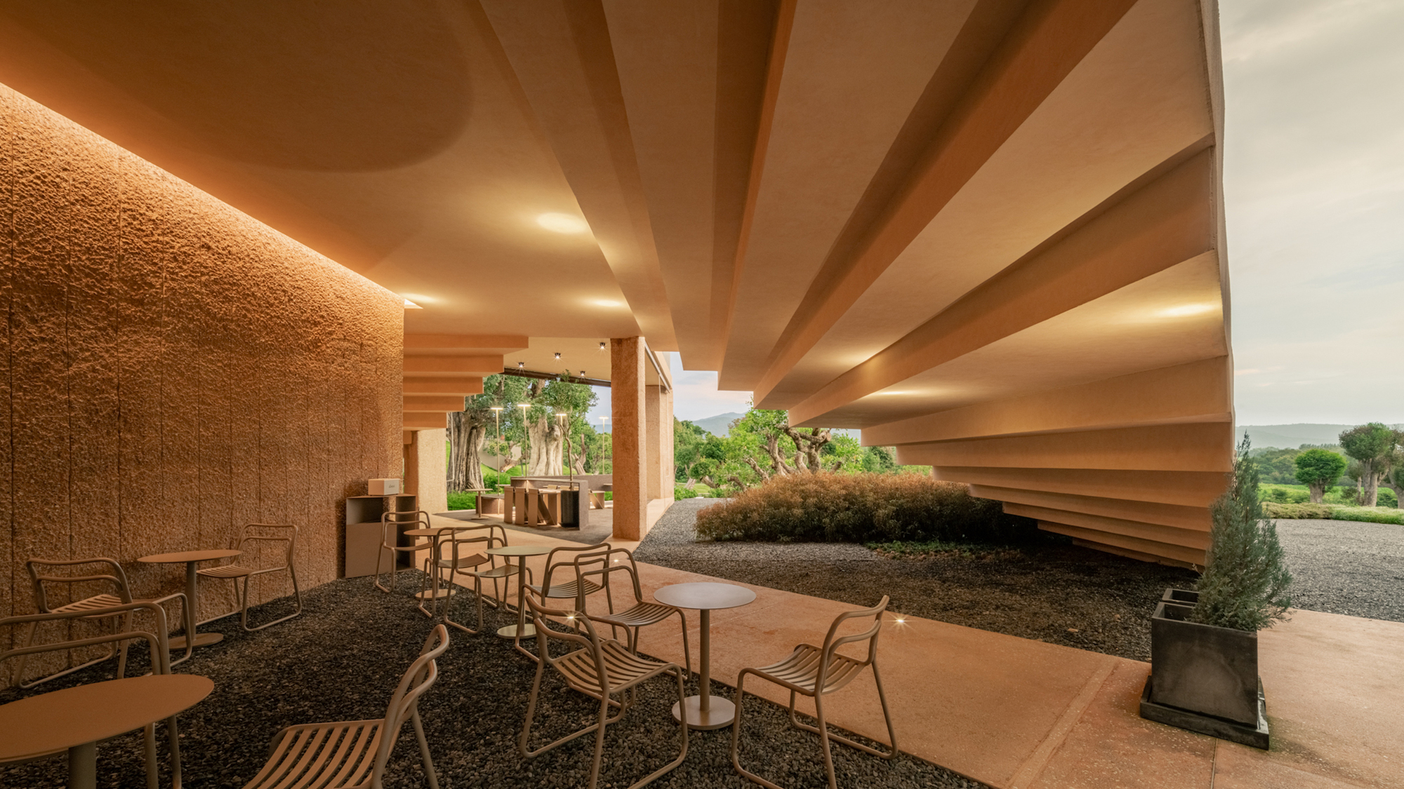 Covered terrace with stepped ceiling beams and scattered seating overlooking the golf course