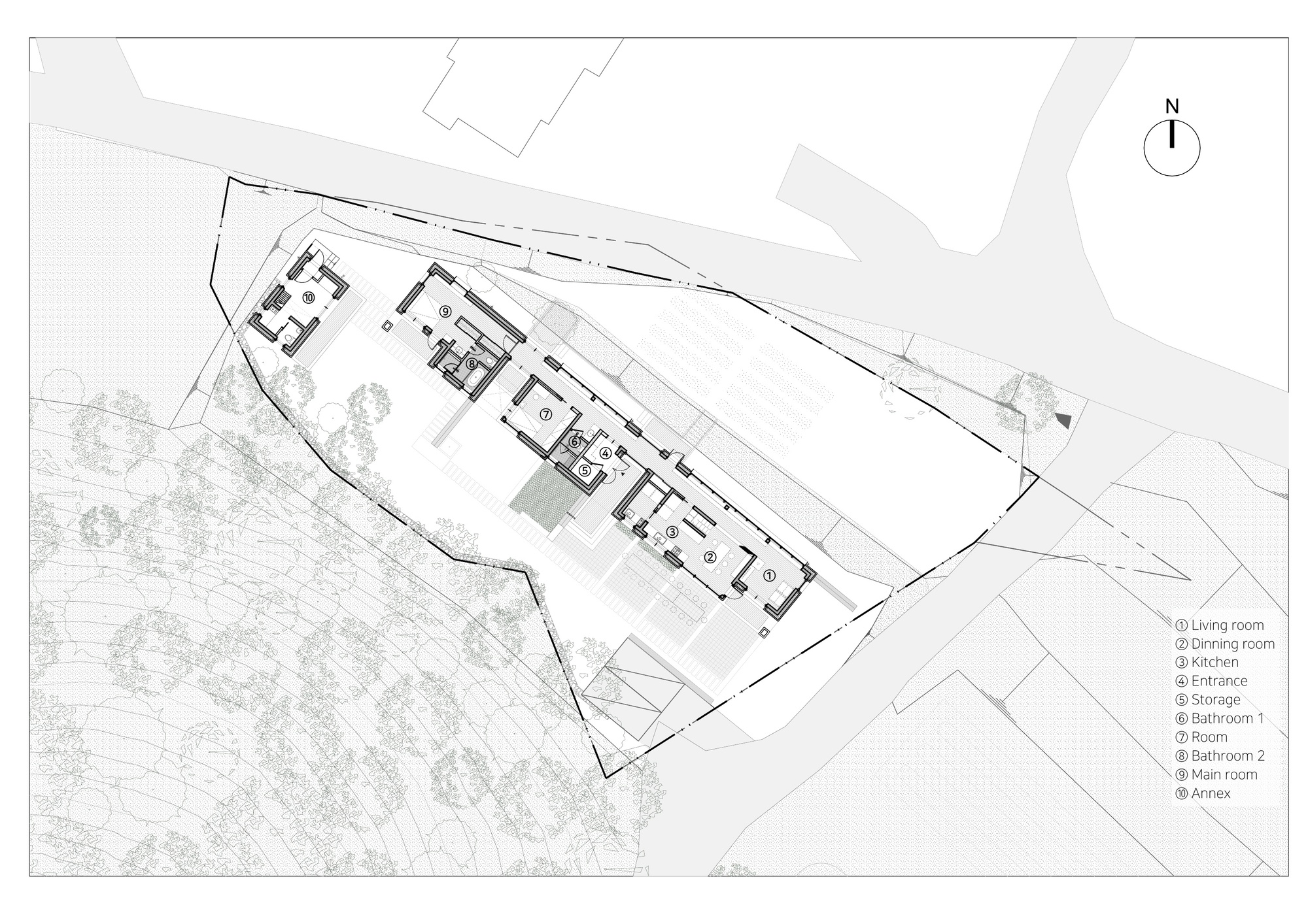 Site plan drawing showing the elongated building footprint on a triangular sloped lot with trees