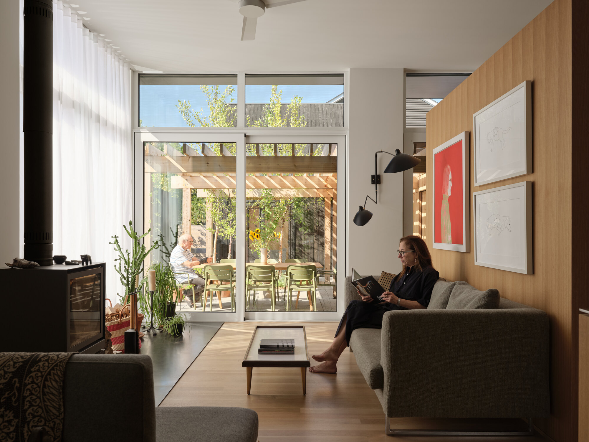 Living area looking toward the glass doors opening onto the timber pergola and courtyard