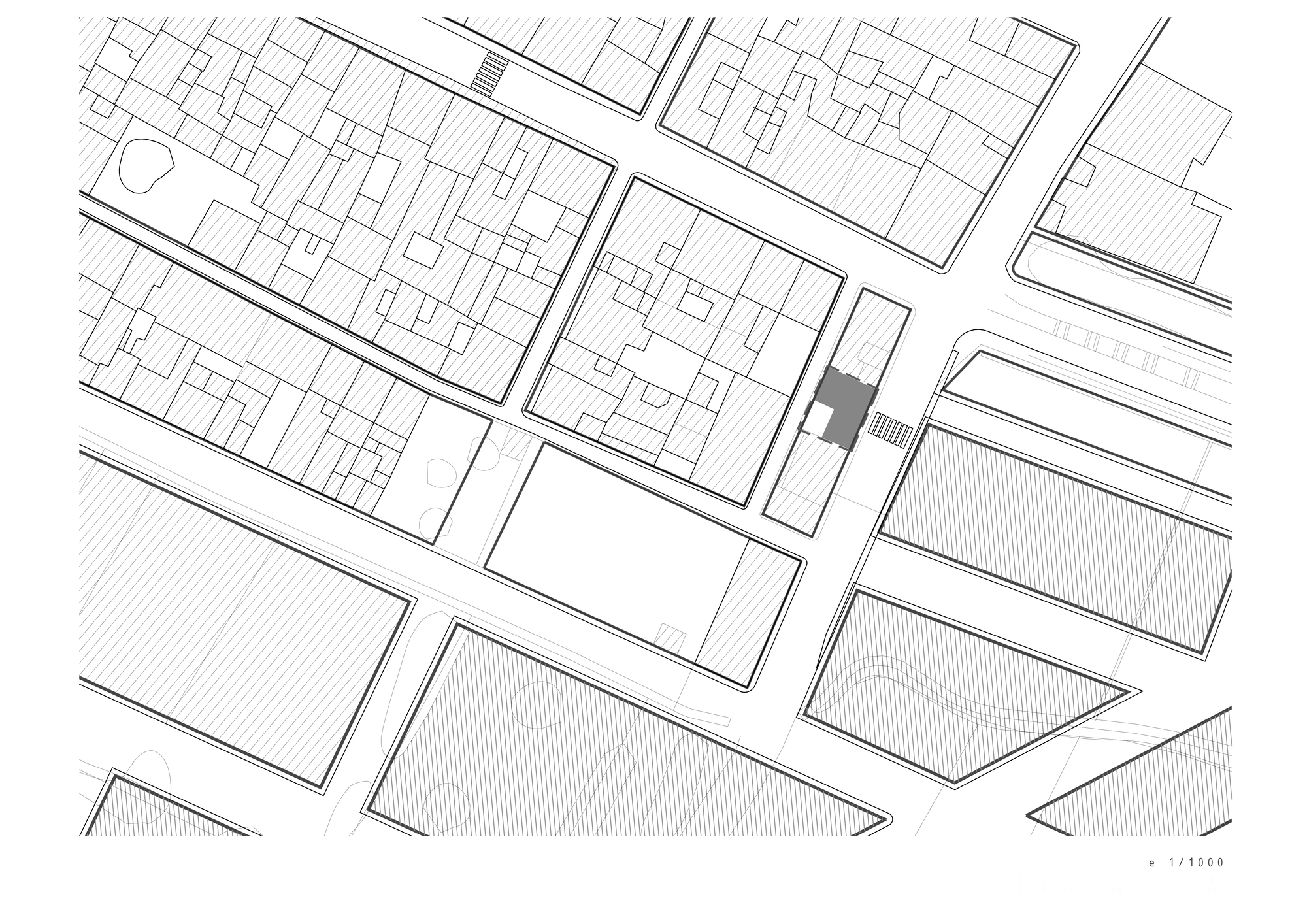 Site plan drawing showing the building footprint highlighted among surrounding urban blocks and streets
