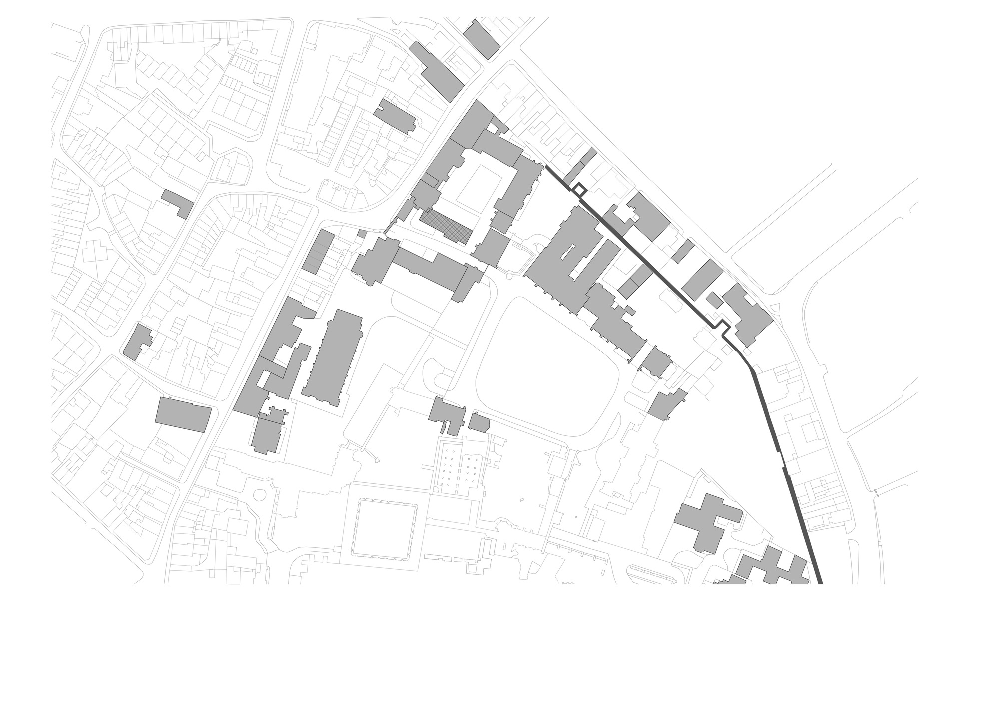 Site plan drawing showing a cluster of buildings within an urban block with surrounding street grid