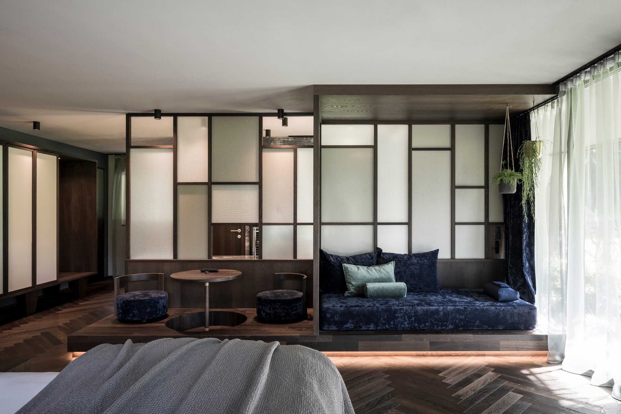Raised platform seating area with integrated strip lighting beneath the dark timber base