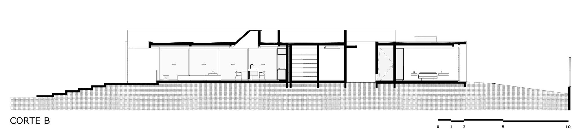 Section drawing showing the building stepping down the slope with multiple interior rooms