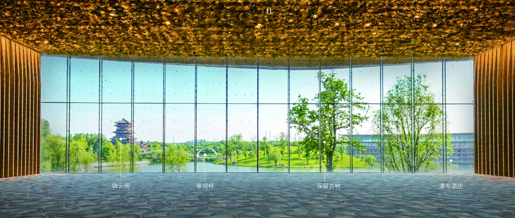 Interior view through floor-to-ceiling glass overlooking trees and a distant pagoda