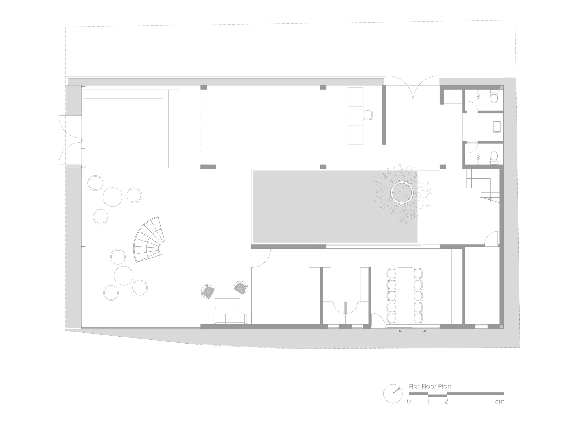 First floor plan drawing showing open spaces with a central courtyard and spiral stair