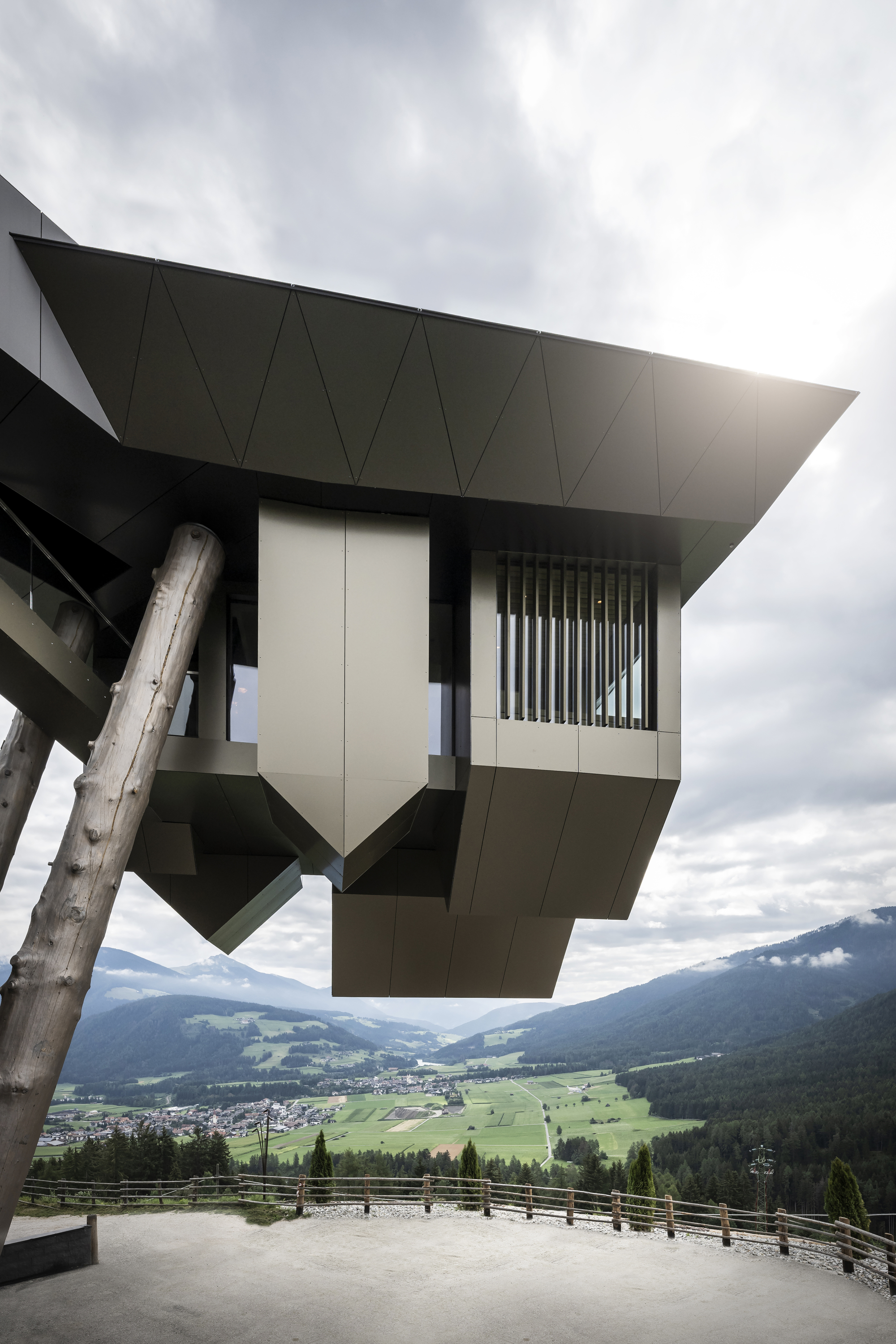 Underside view of the angular cantilever with vertical louvers overlooking a valley below