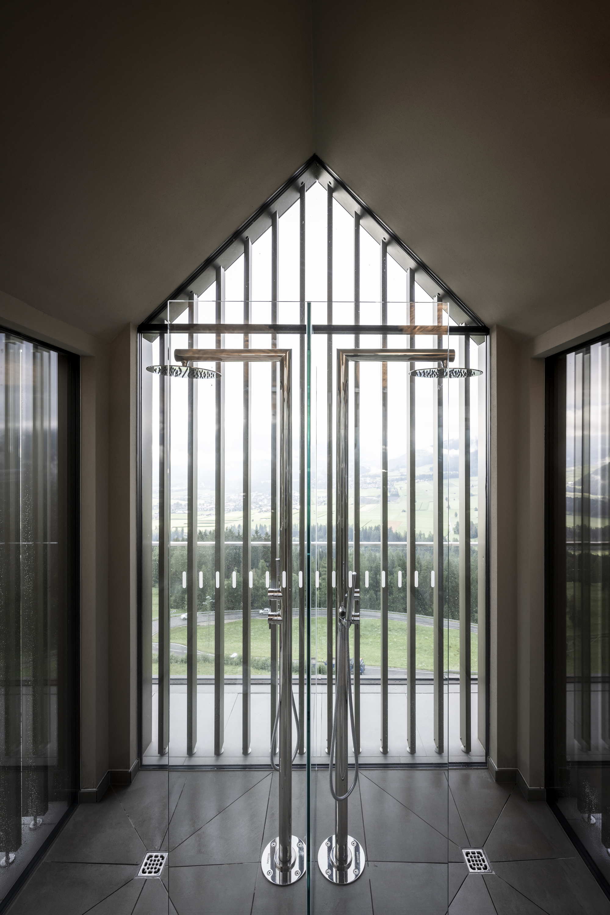 Interior entrance vestibule with vertical slat door and polished chrome handles on tiled floor
