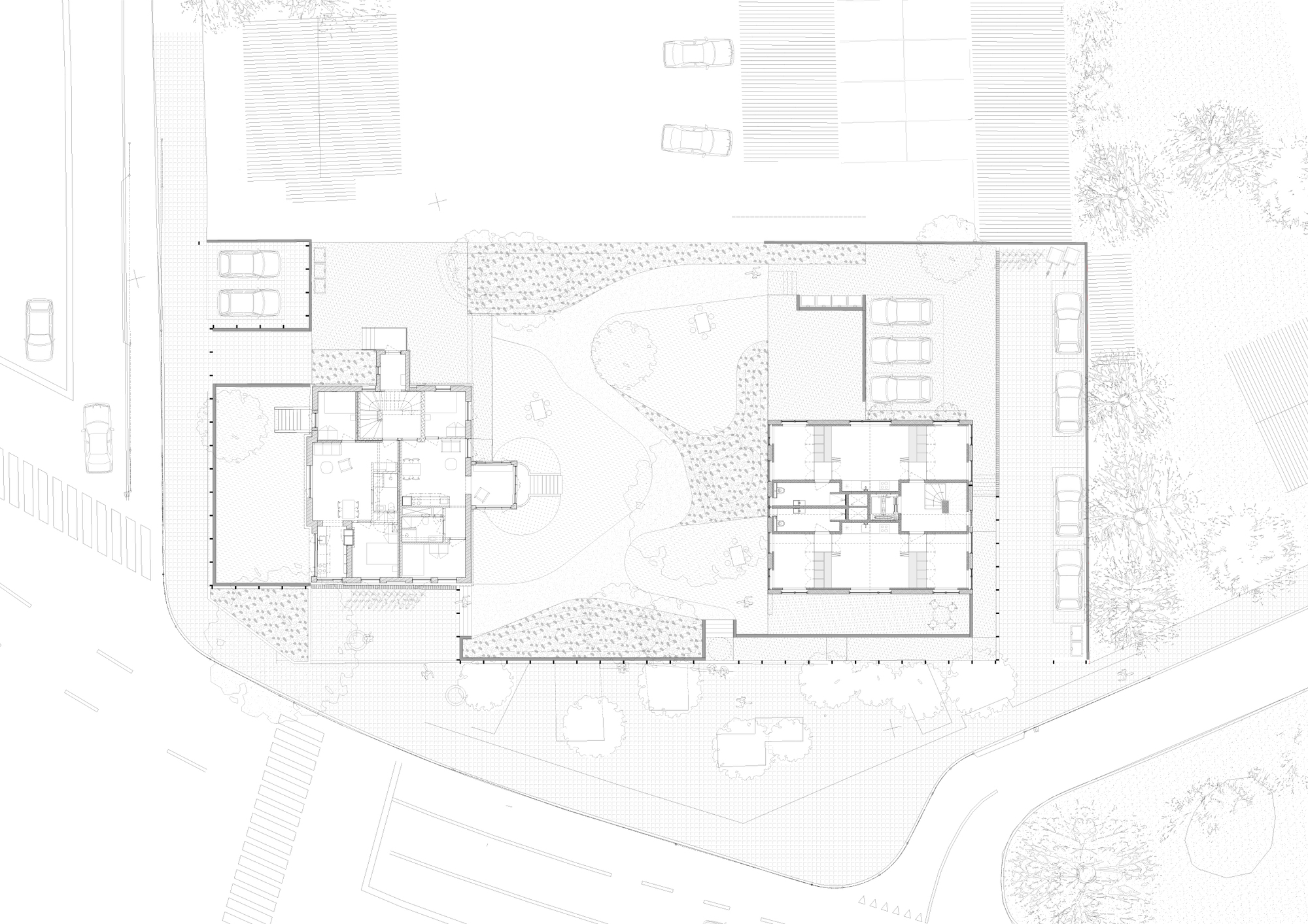 Site plan drawing showing two rectangular buildings flanking a courtyard with landscaping and parking areas