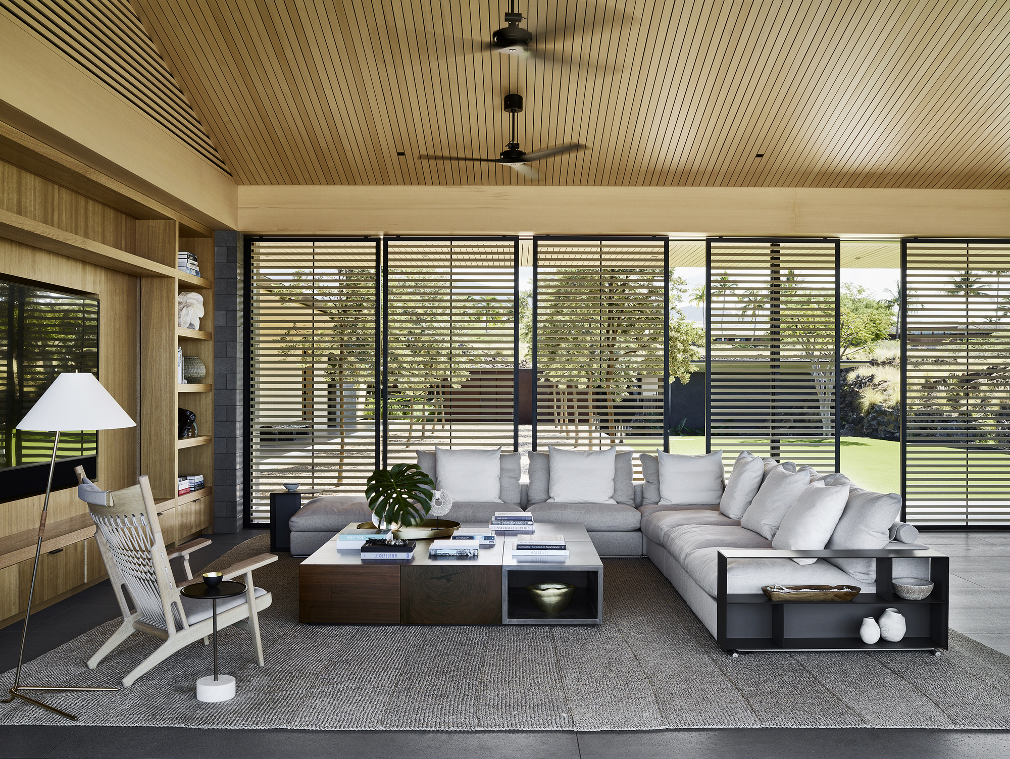 Living room with horizontal louvered screens and slatted timber ceiling under daylight