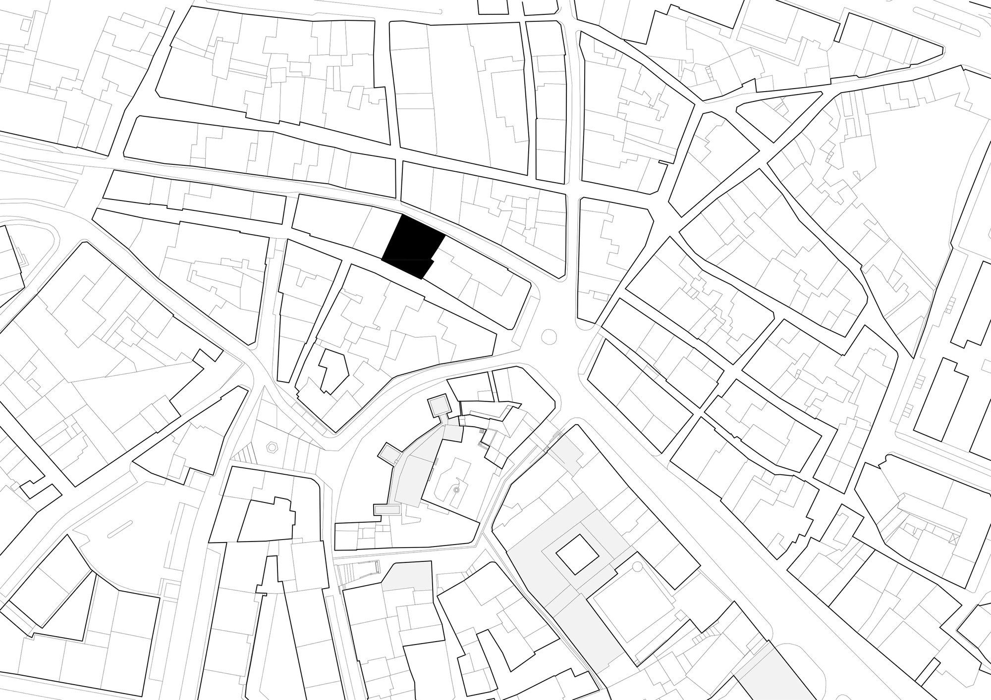 Site plan drawing showing a single highlighted building footprint within the surrounding urban fabric