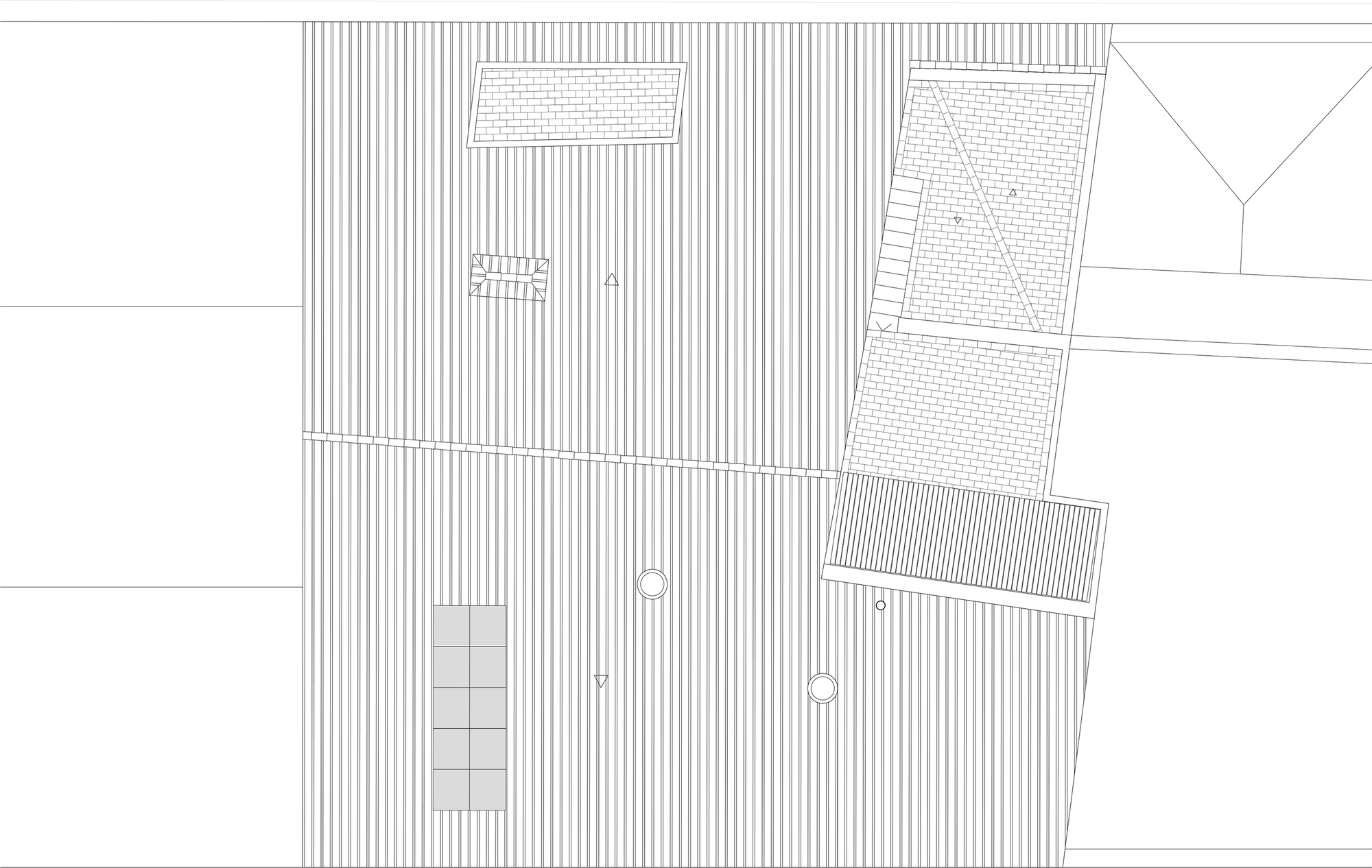 Site plan drawing showing the building footprint with striped paving and adjacent structures