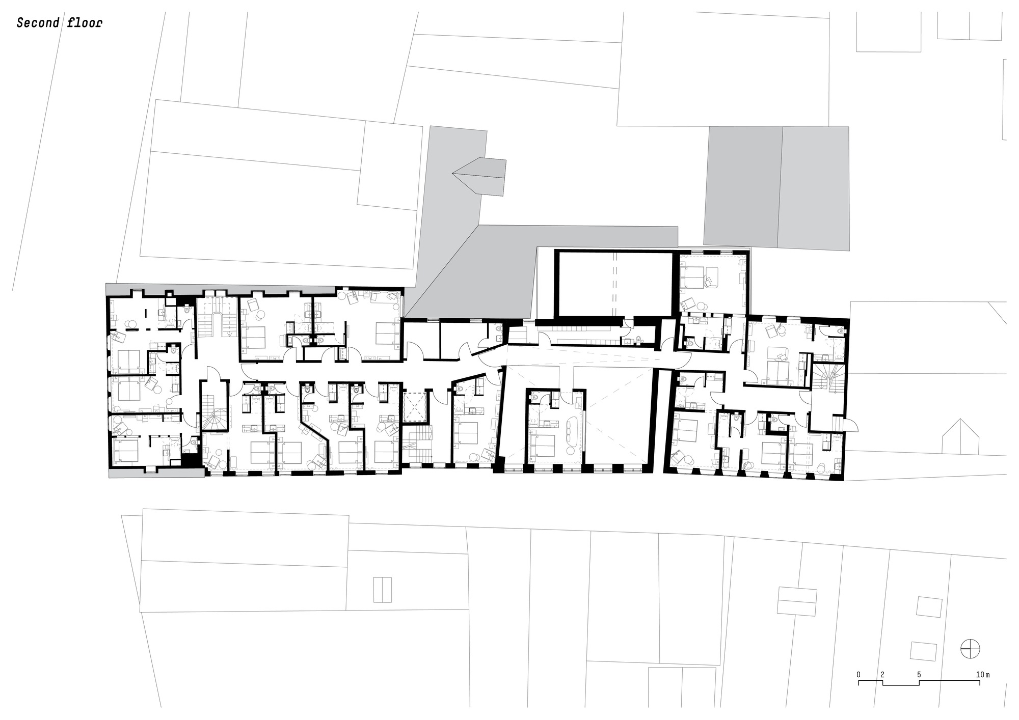 Second floor plan drawing showing residential units with adjacent rooftop terraces indicated in grey