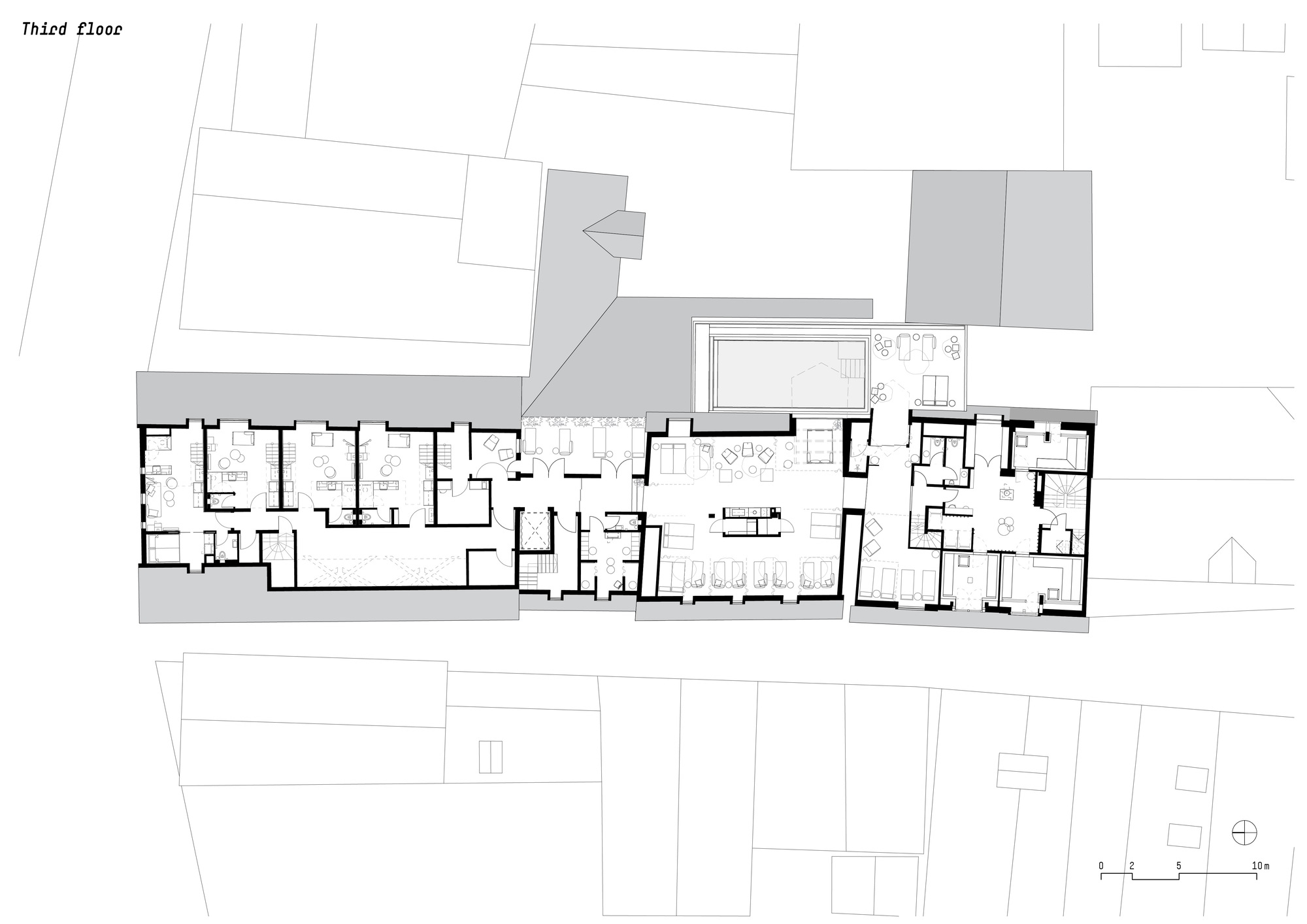 Third floor plan drawing showing residential units with central communal space and surrounding terrace areas