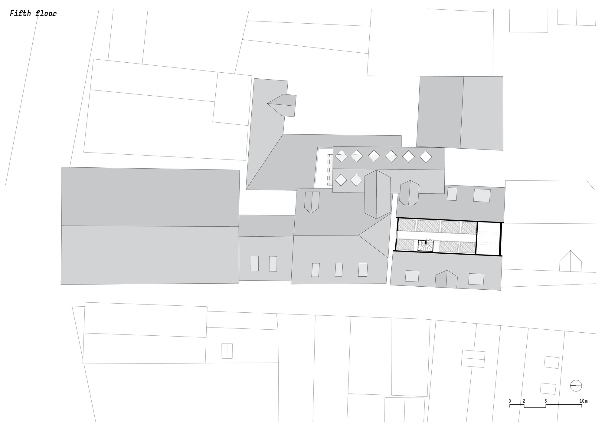 Fifth floor plan drawing showing irregularly shaped volumes with interior furnishings and surrounding context